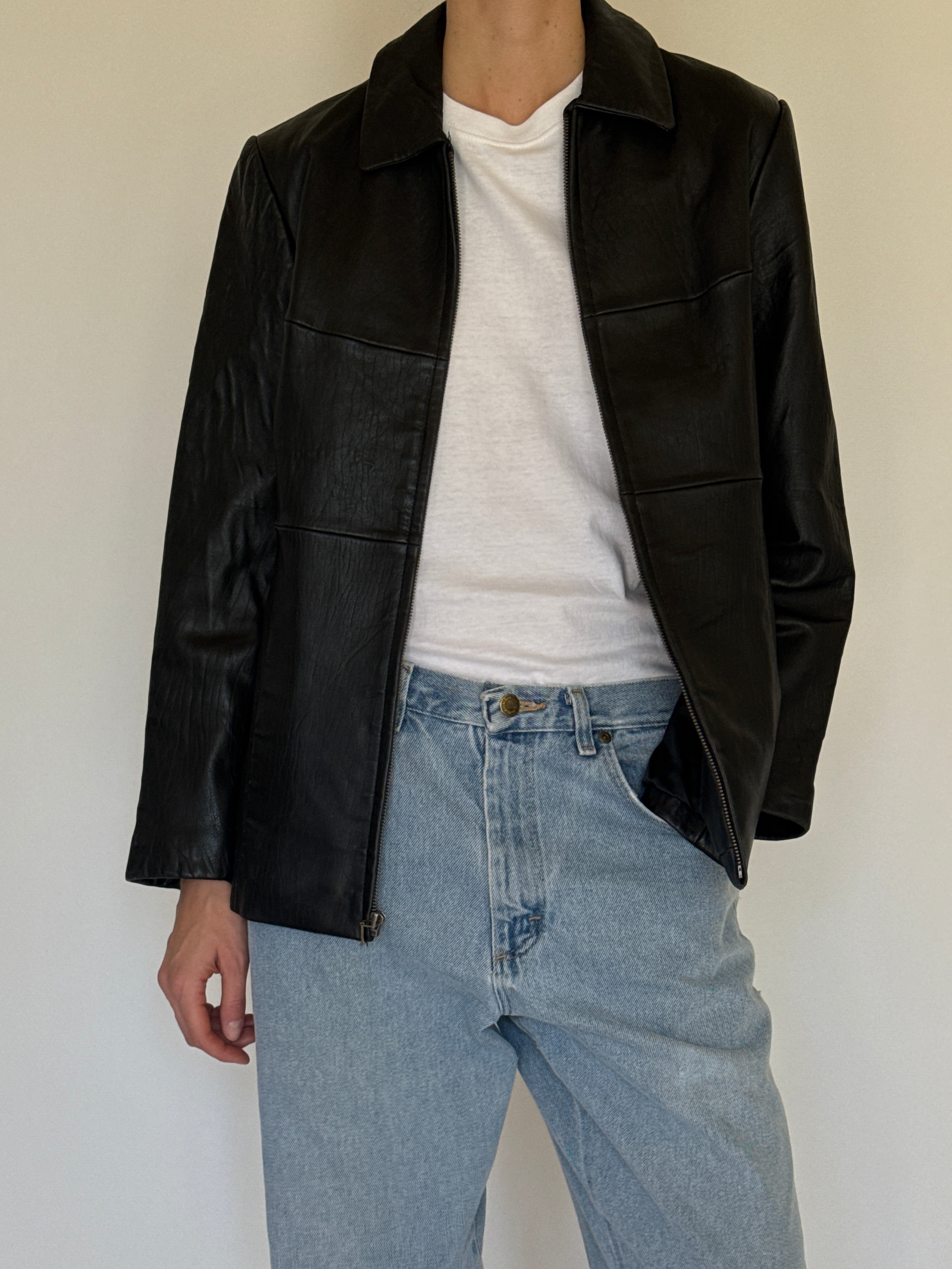 Vintage black leather jacket fabric close-up smooth leather