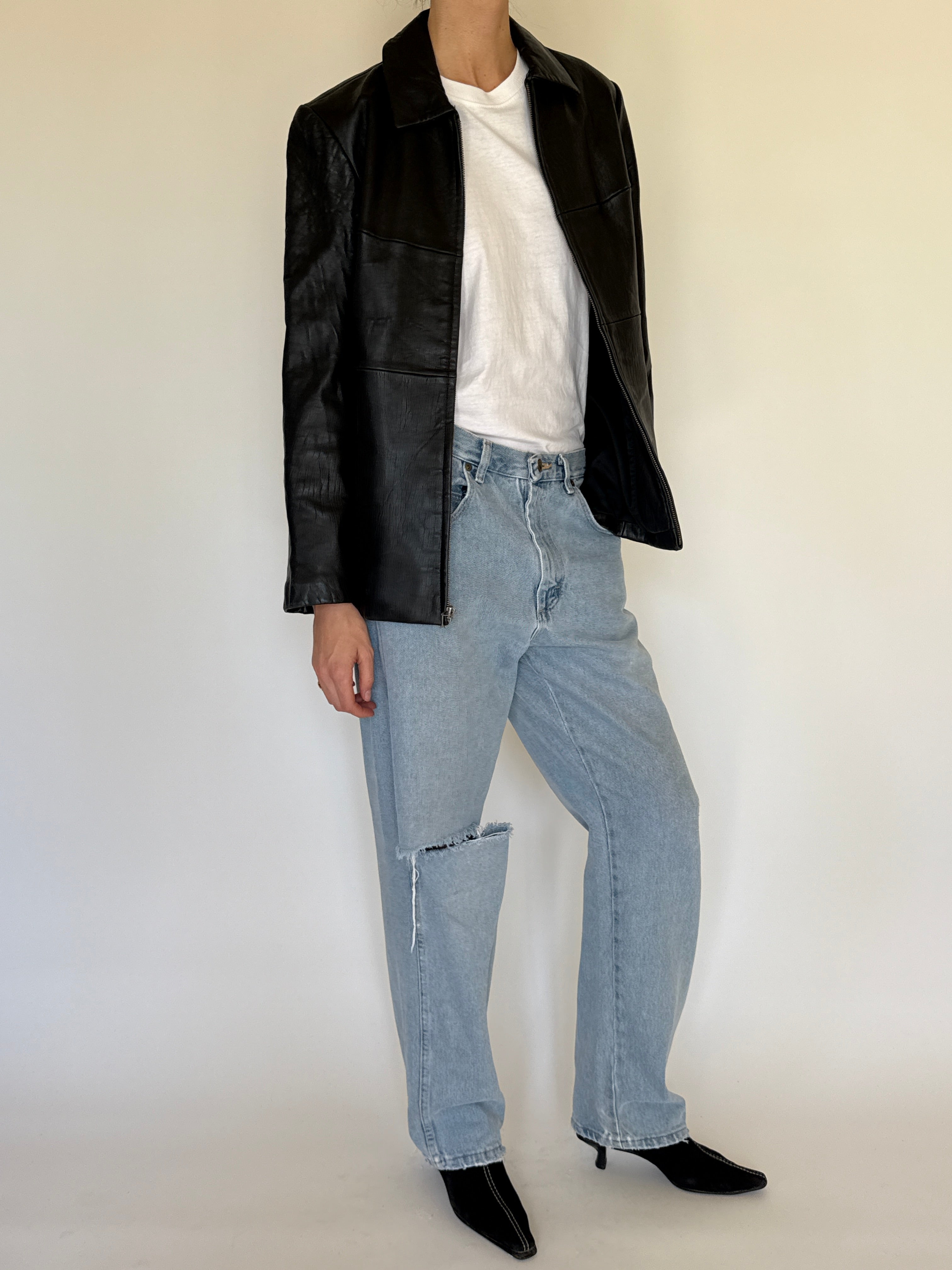 Vintage black leather jacket front view zip closure