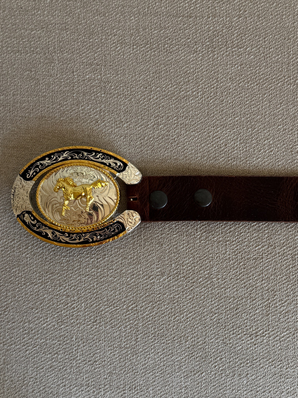 Vintage brown leather western belt buckle and strap detail