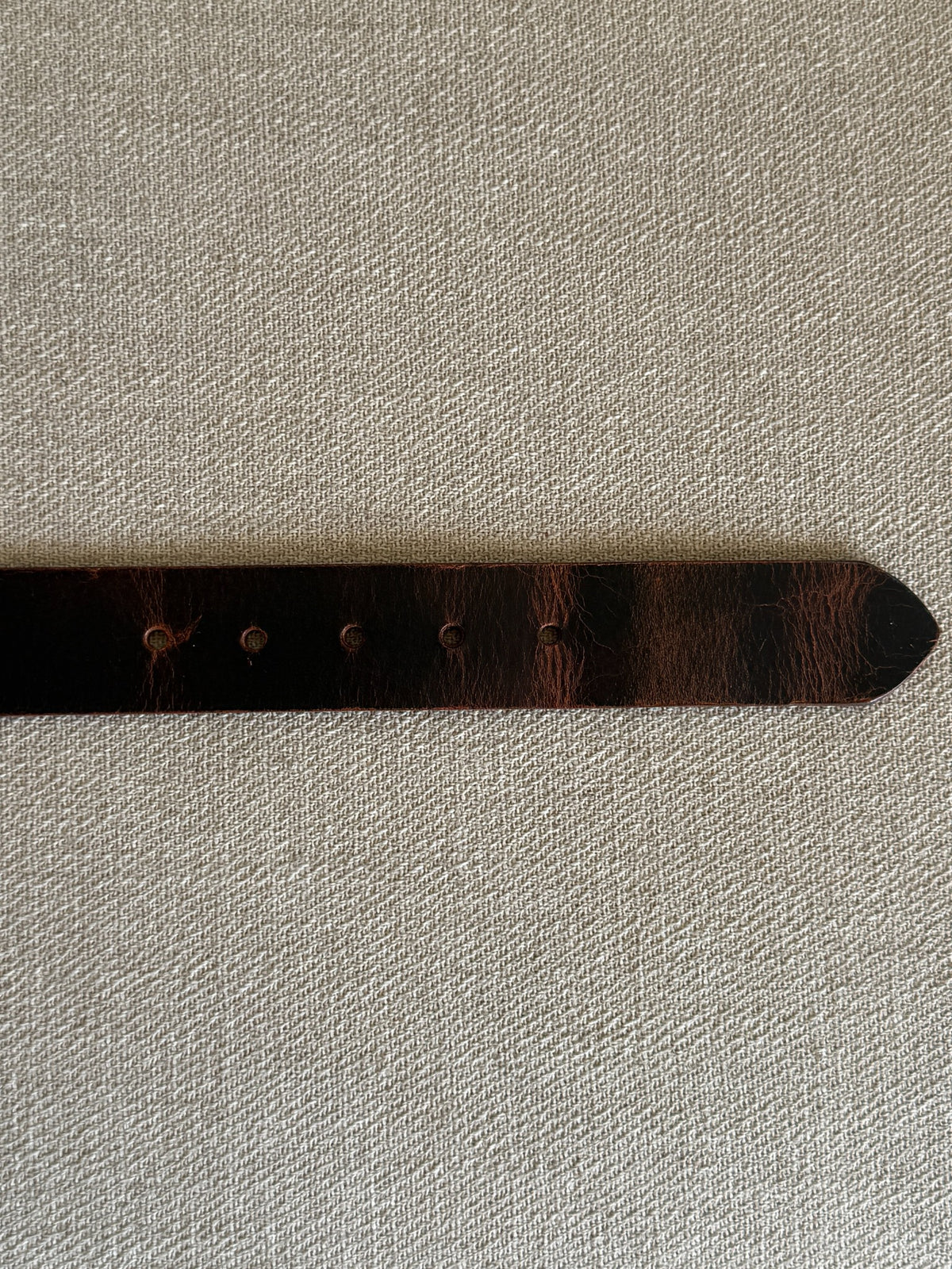 Vintage brown leather western belt adjustment holes detail