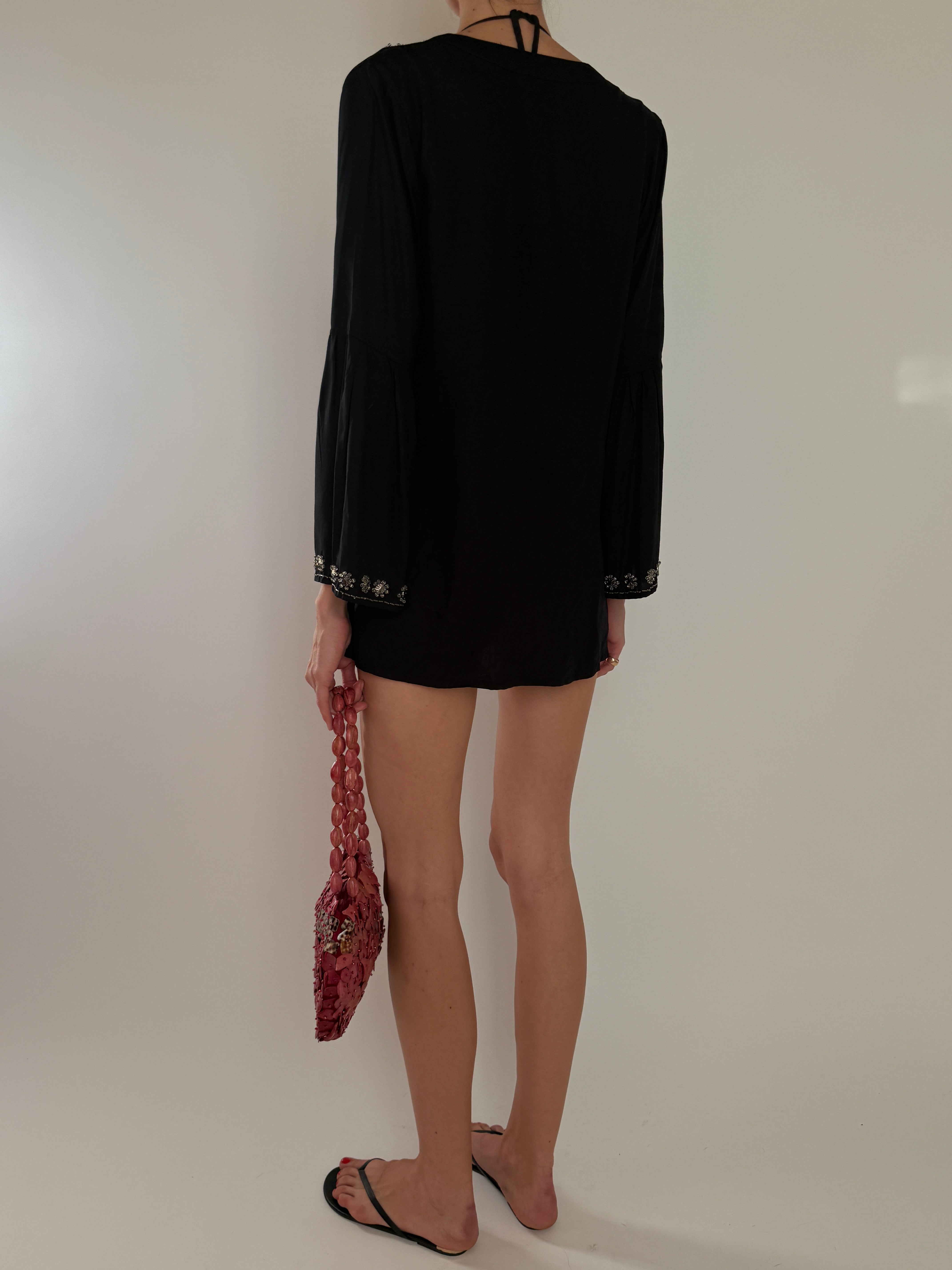 Vintage black embellished tunic dress with silver beaded neckline and long sleeves back view