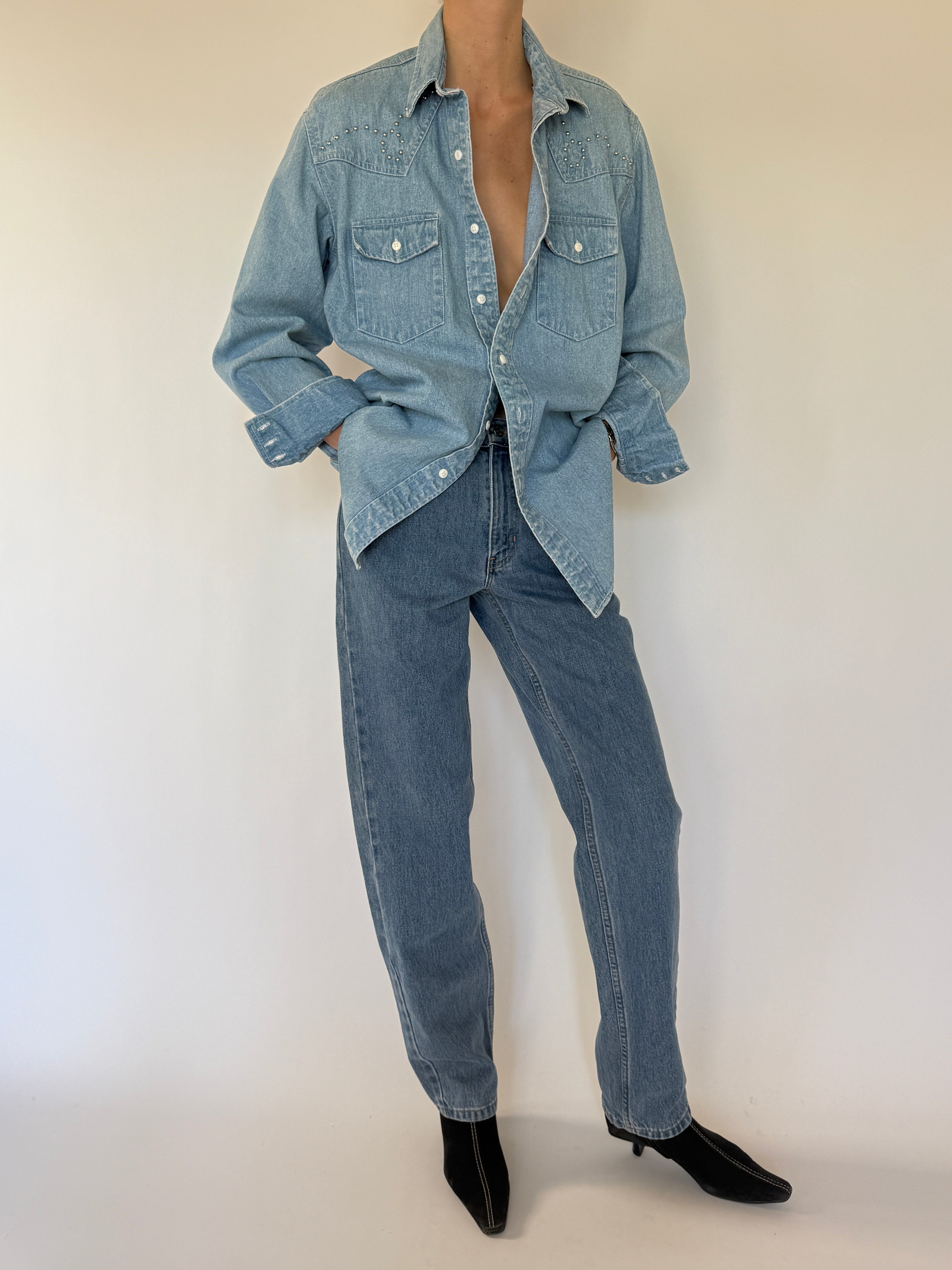 Vintage western-inspired blue studded denim shirt front view with chest pockets