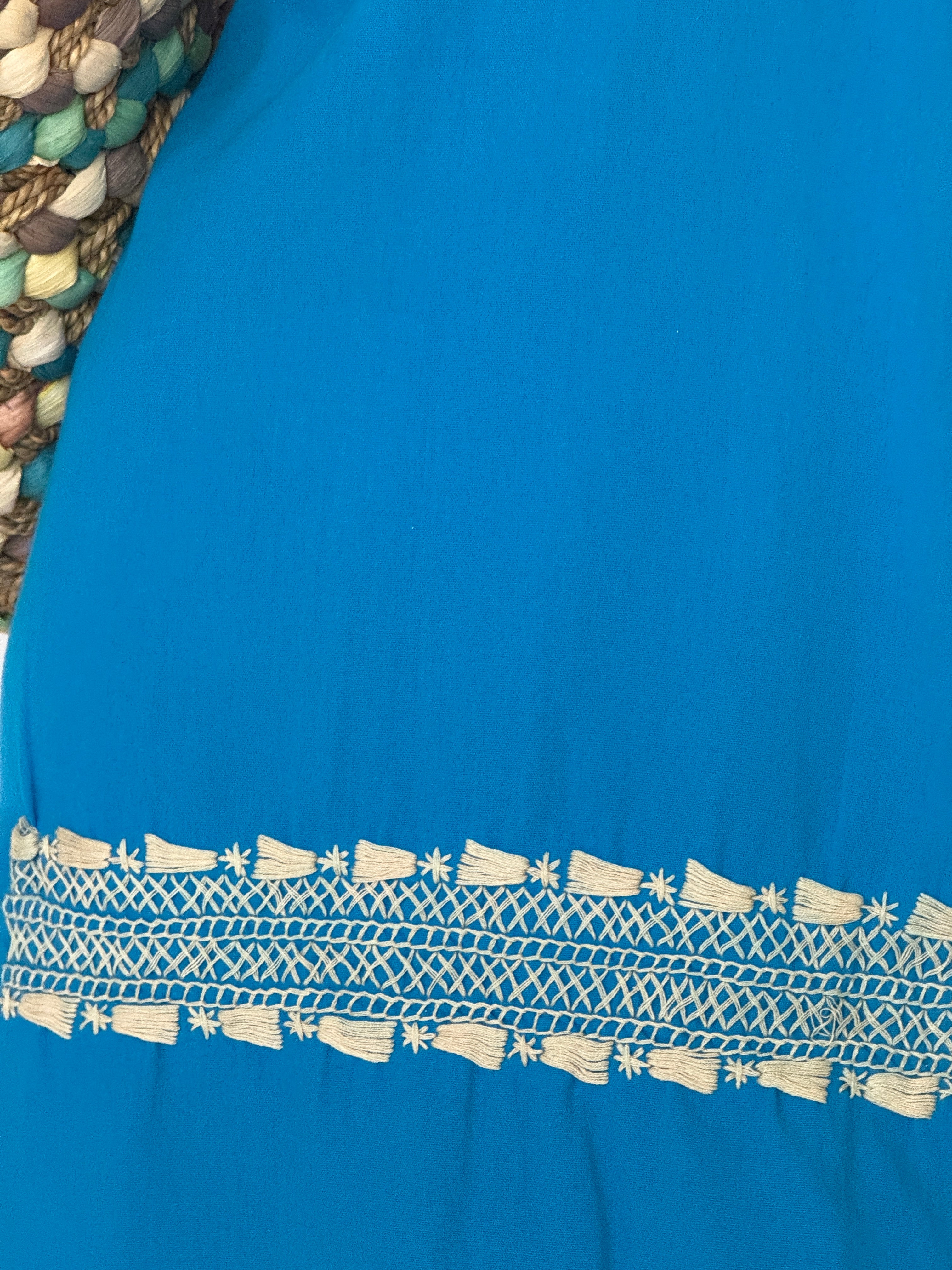 Vintage turquoise embroidered neckline close-up