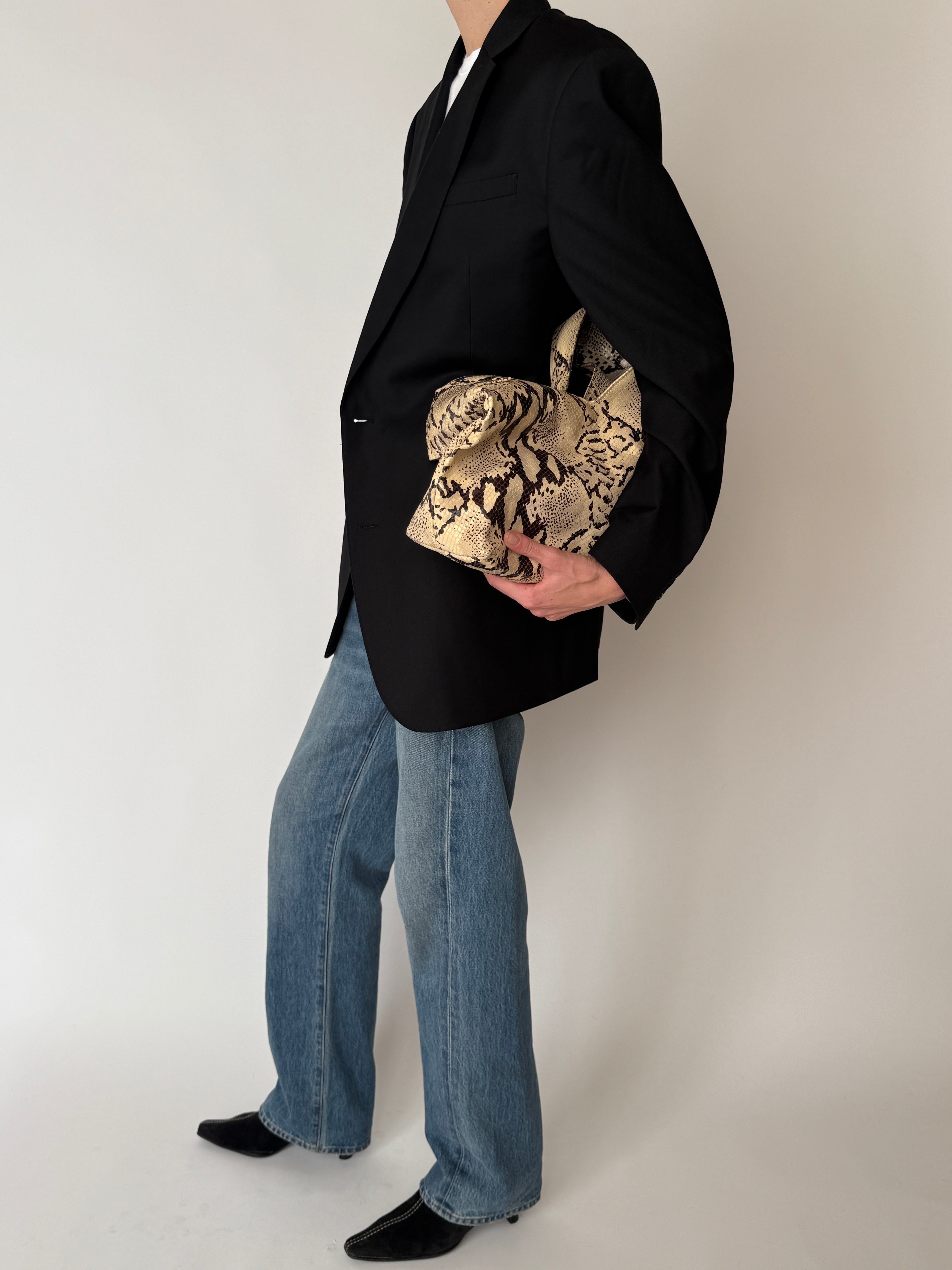 Vintage Italian-made black blazer shown from the side
