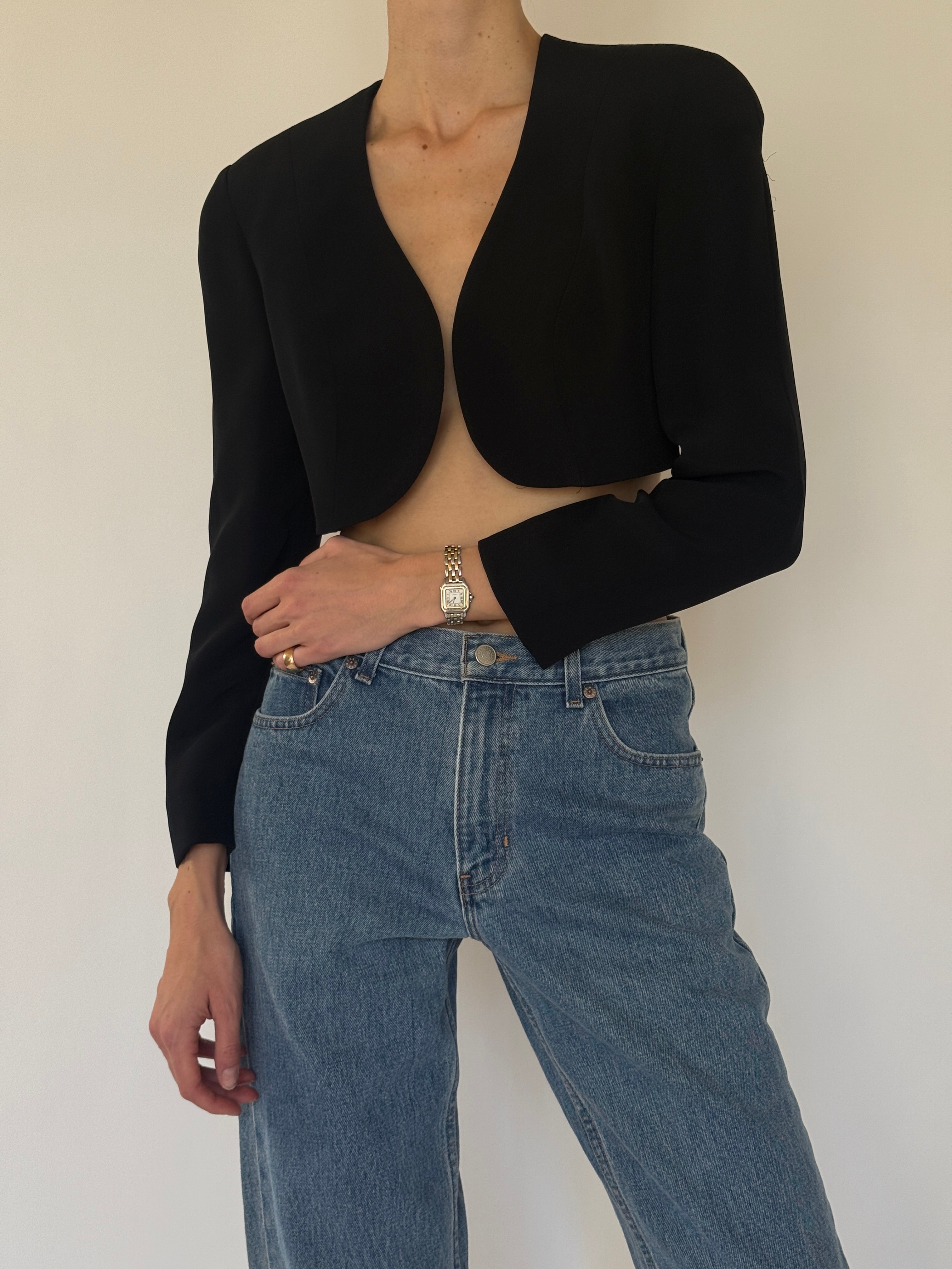 Vintage black cropped blazer fabric close-up