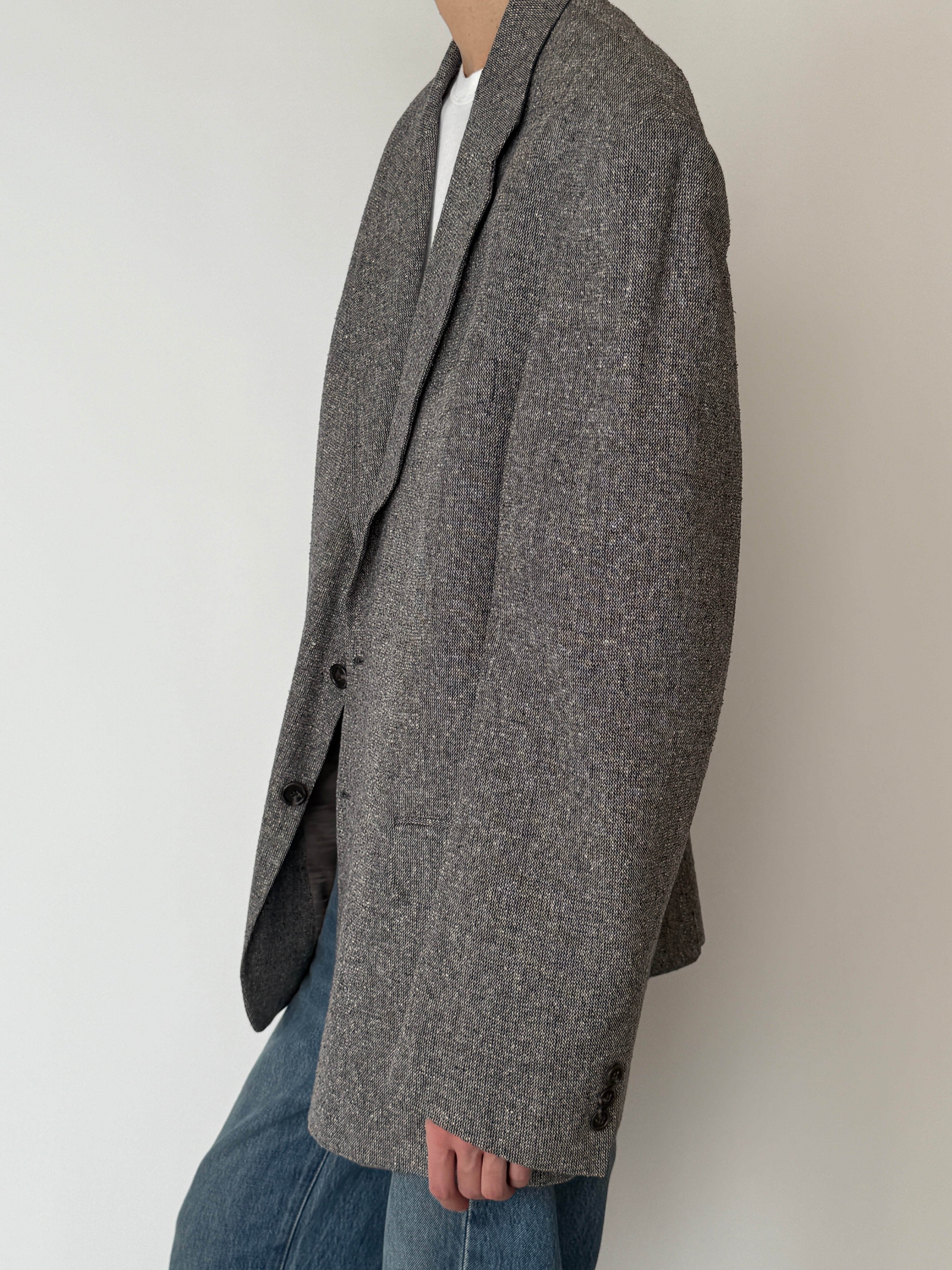 Vintage fully lined silk blazer with front flap pockets and back vent in grey side view