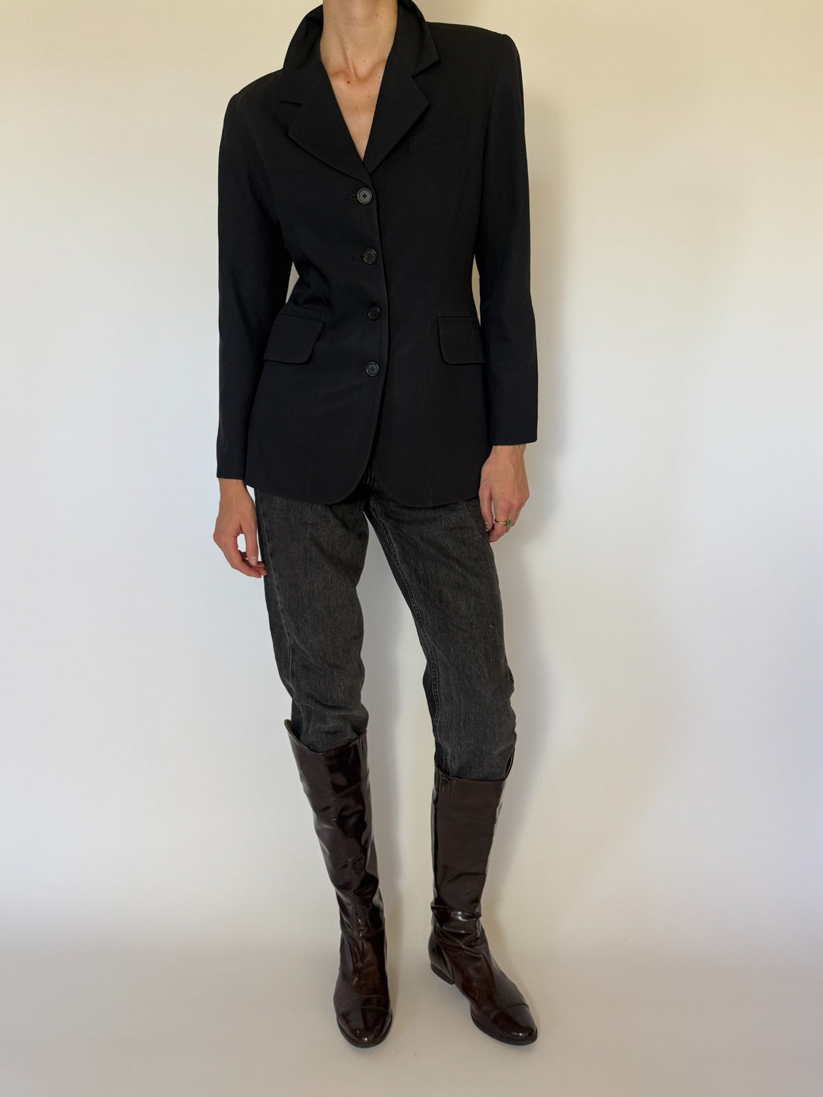 Front view of vintage fitted navy blue blazer buttoned