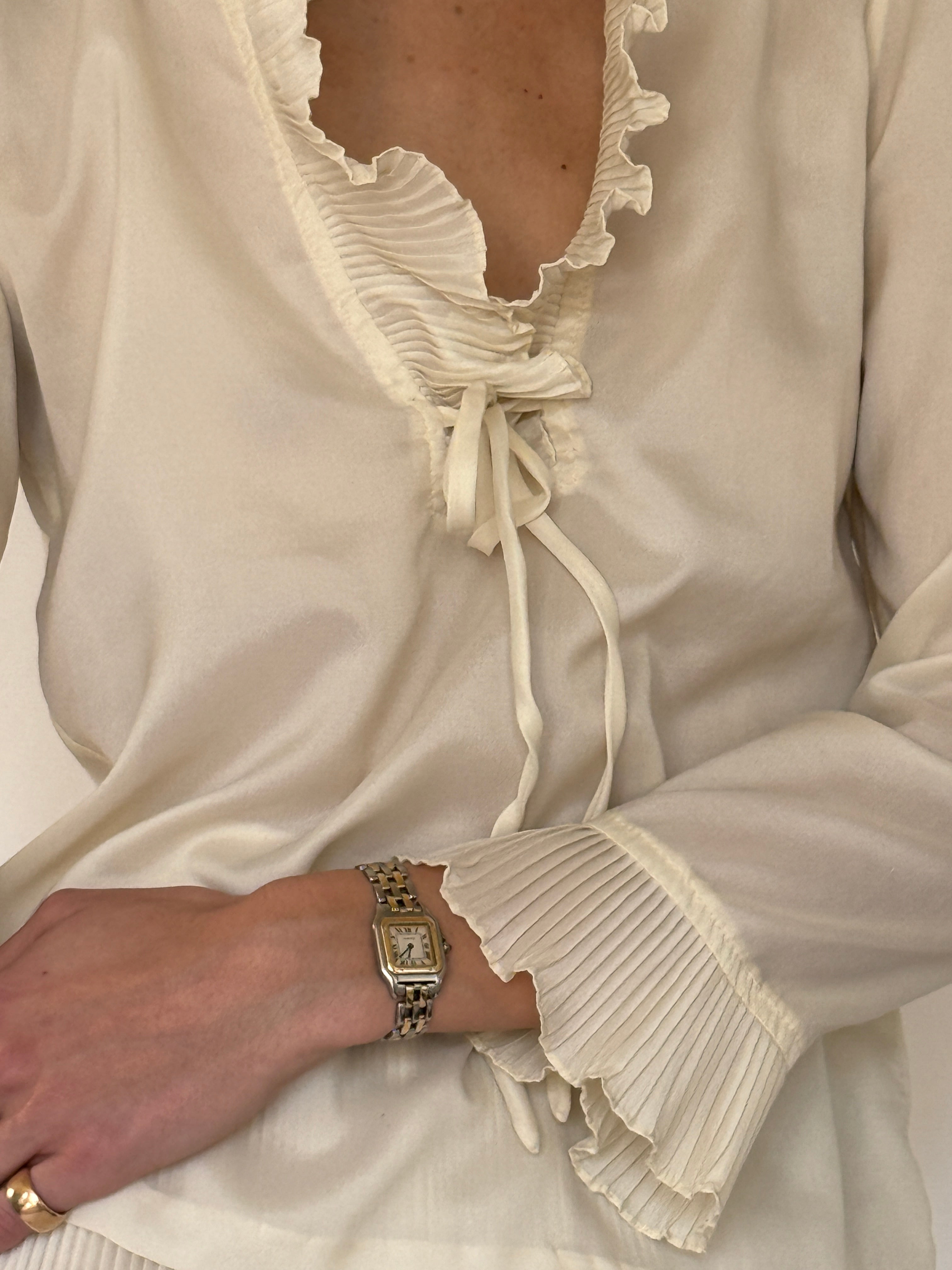 Vintage cream blouse and pleated skirt set fabric close-up