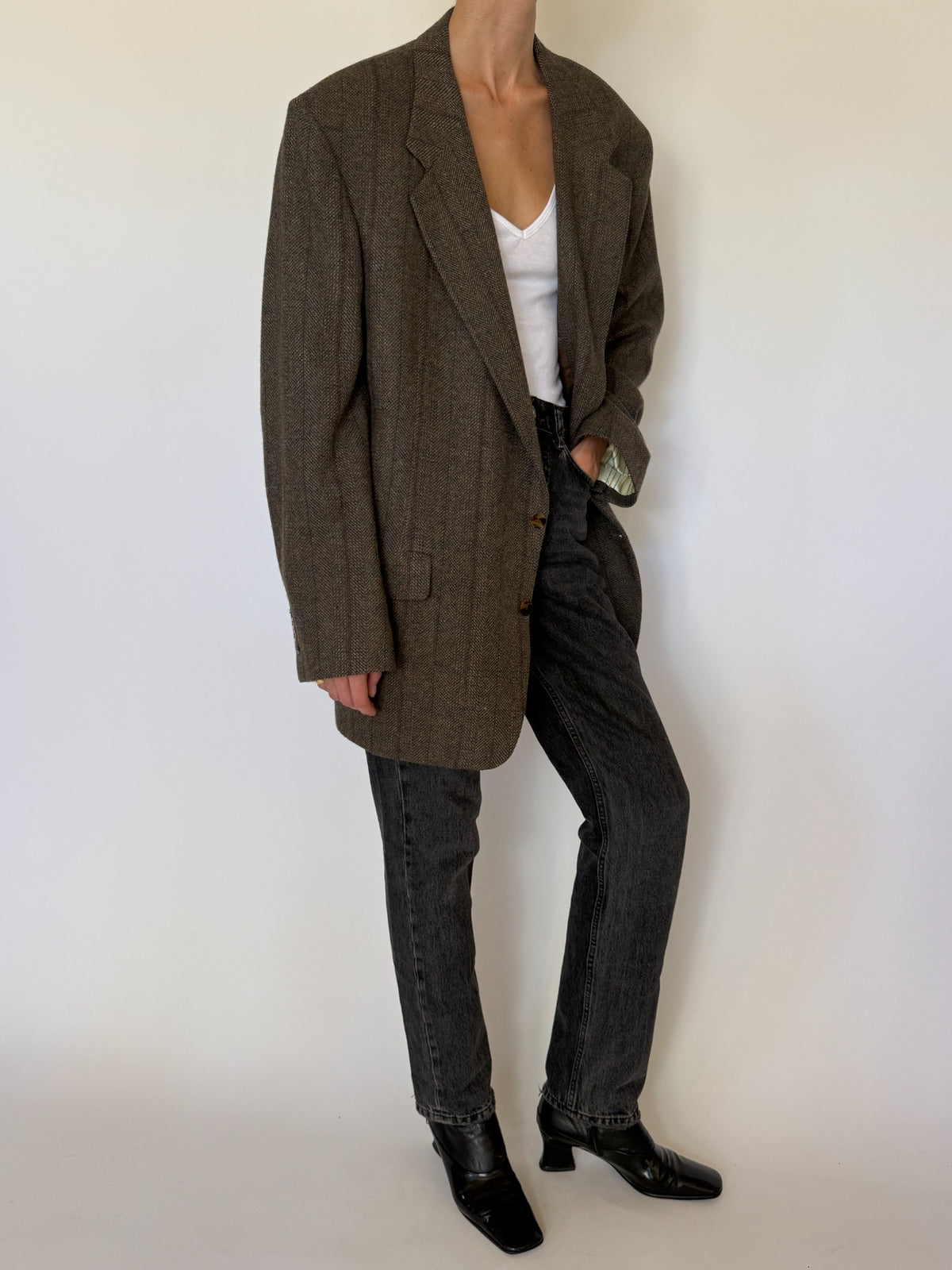 Front angled view of vintage brown herringbone oversized wool blazer