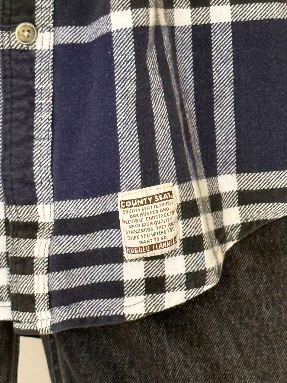 Three quarter front view of vintage navy plaid button front shirt