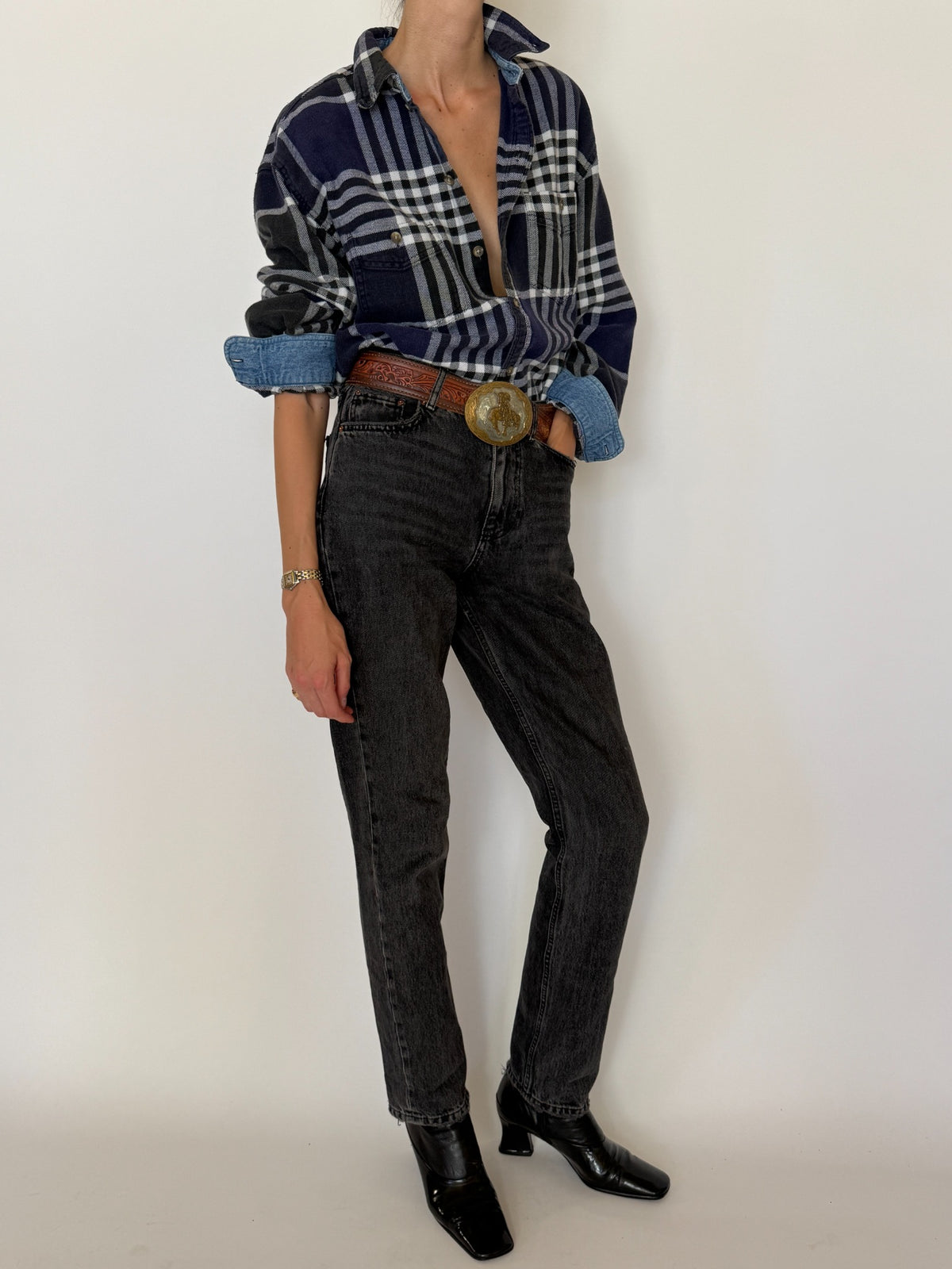 Back view of vintage navy plaid shirt showing pleated back yoke