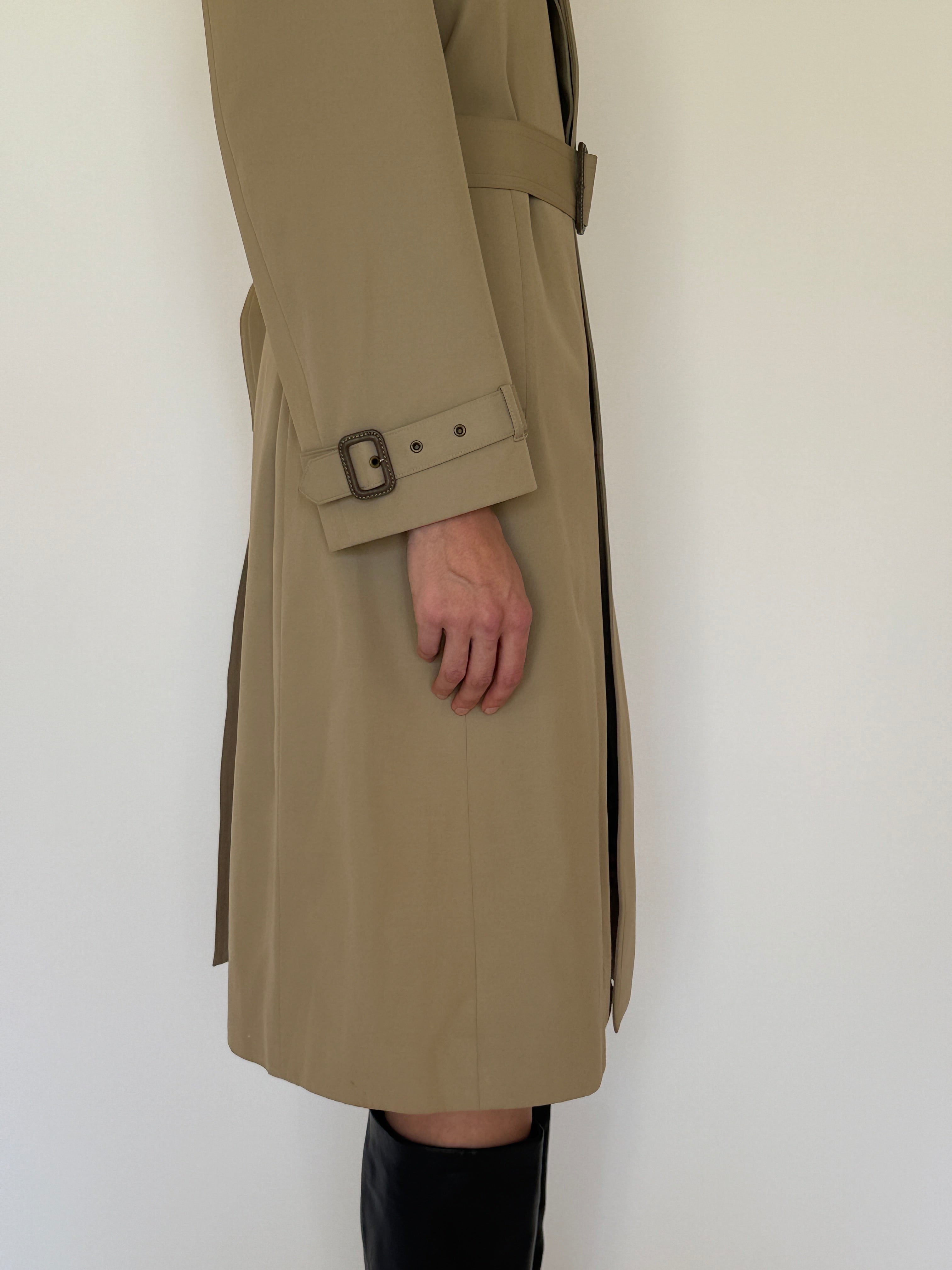 Vintage beige trench coat belt buckle detail close-up