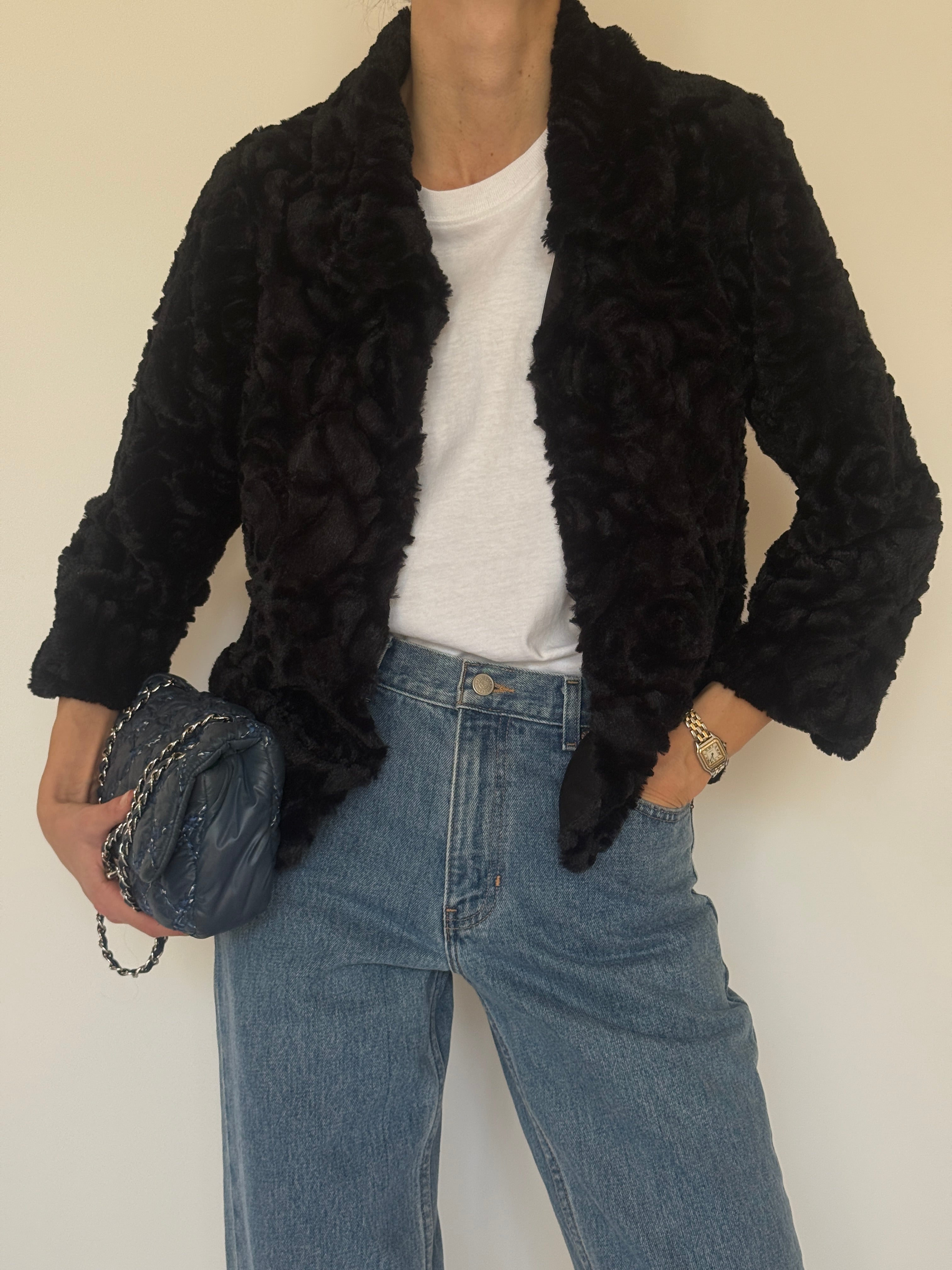 Vintage black faux fur cropped jacket texture close-up