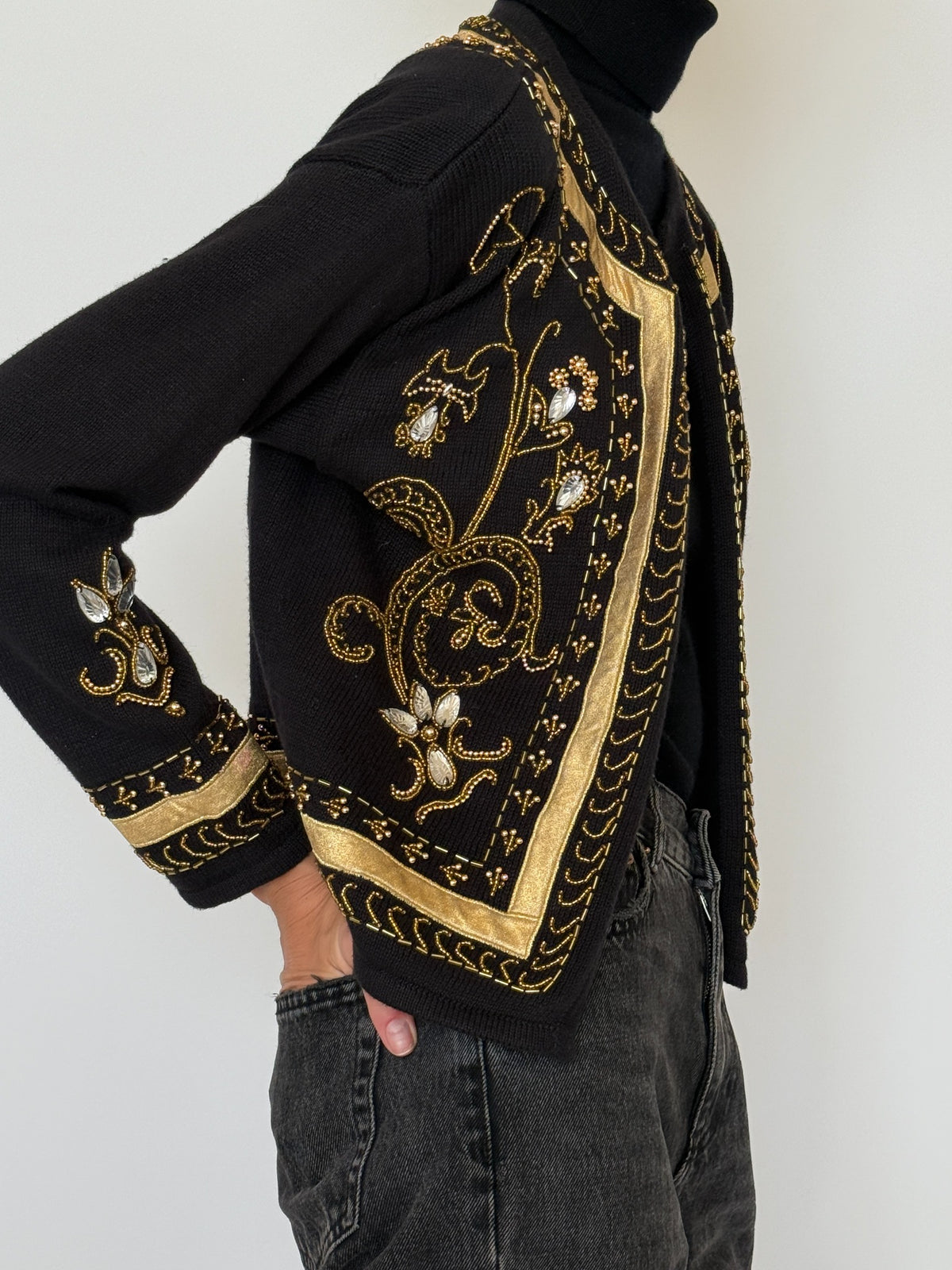 Side view of vintage black knit cardigan with gold beadwork