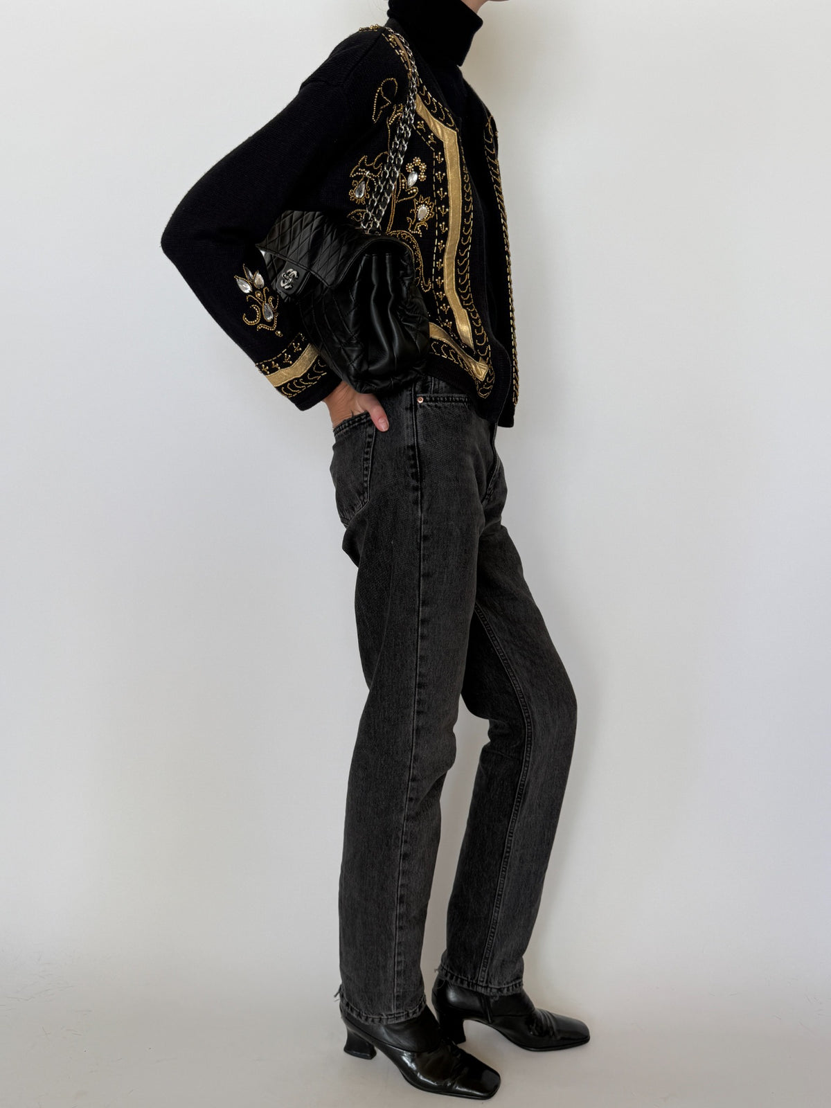 Gold beadwork and decorative embroidered details on black knit
