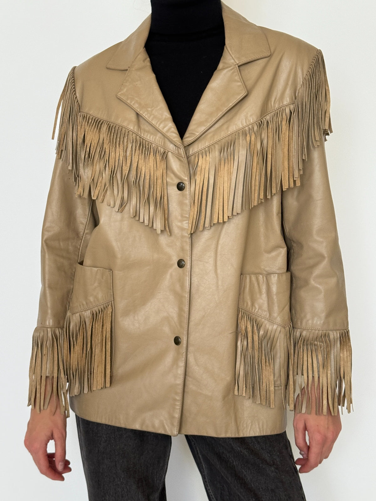 Close-up of leather fringe and snap closure