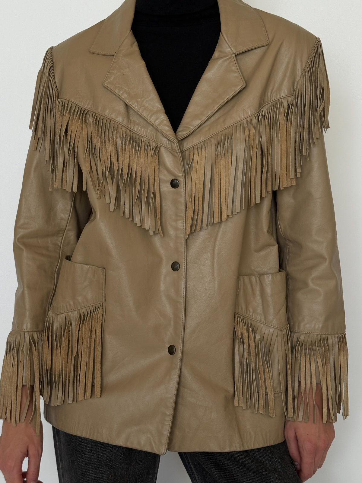 Close-up of leather jacket with fringe details