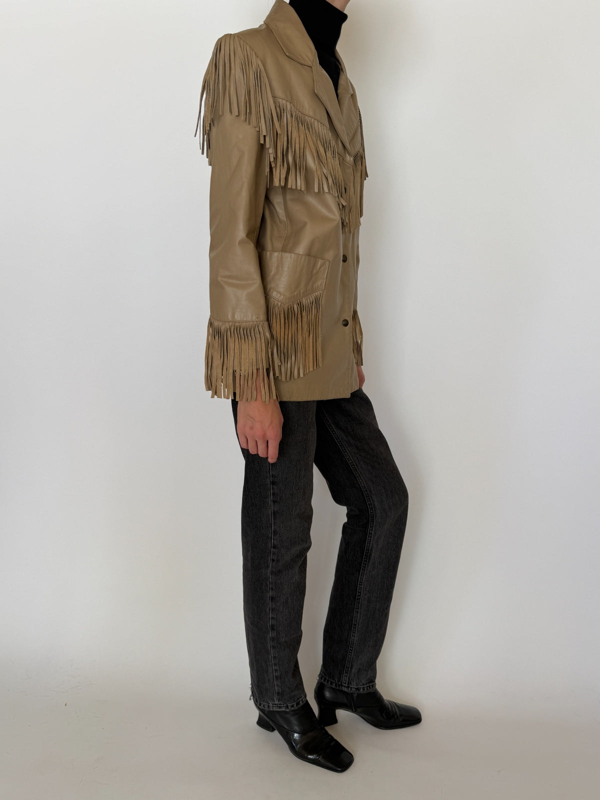 Side profile of tan Western fringe jacket