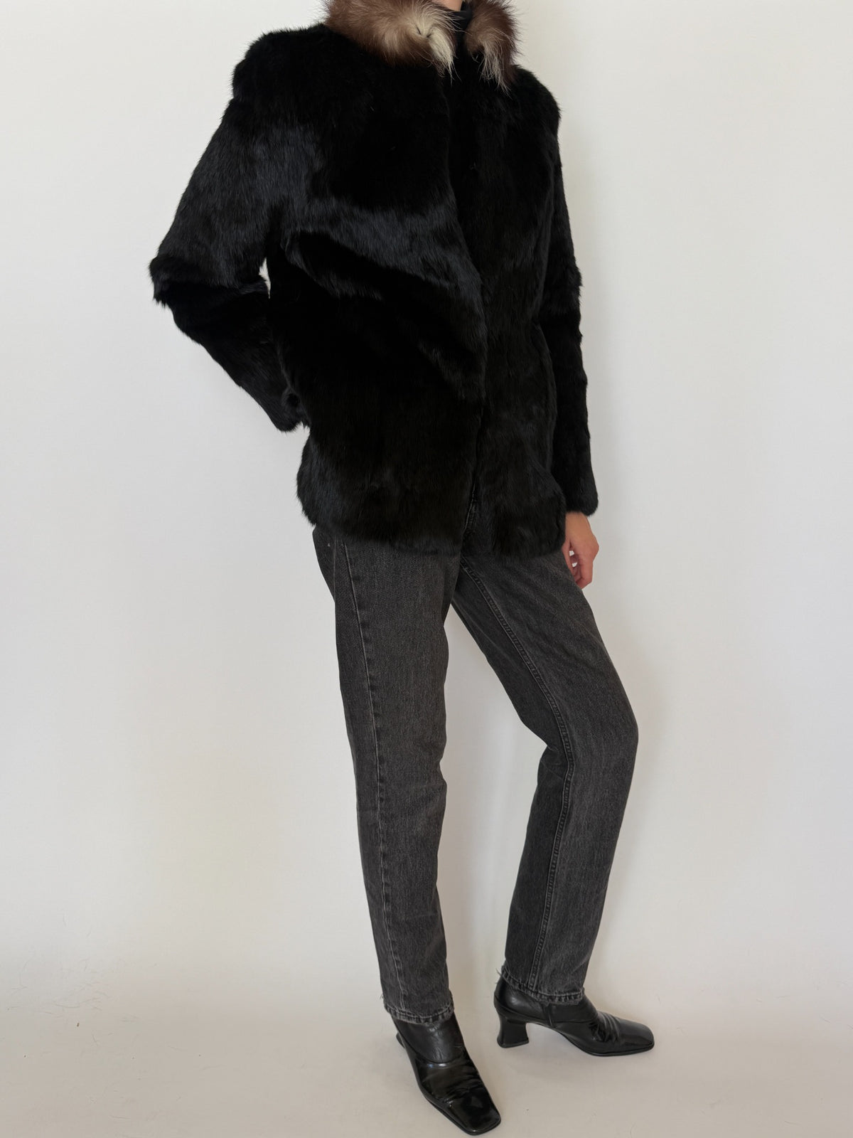 Three-quarter view of black rabbit fur jacket