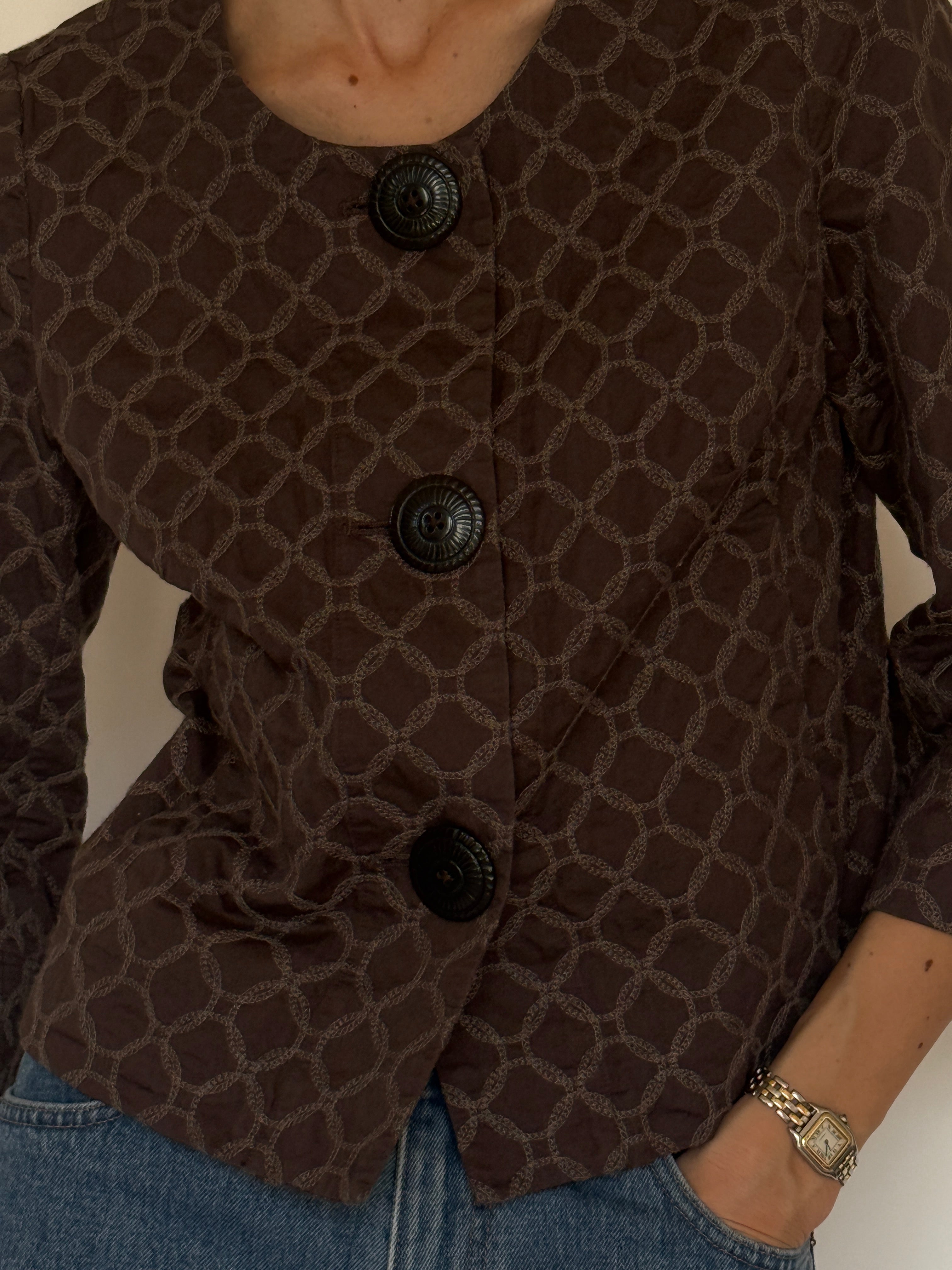 Vintage brown cotton jacket fabric close-up geometric embroidery