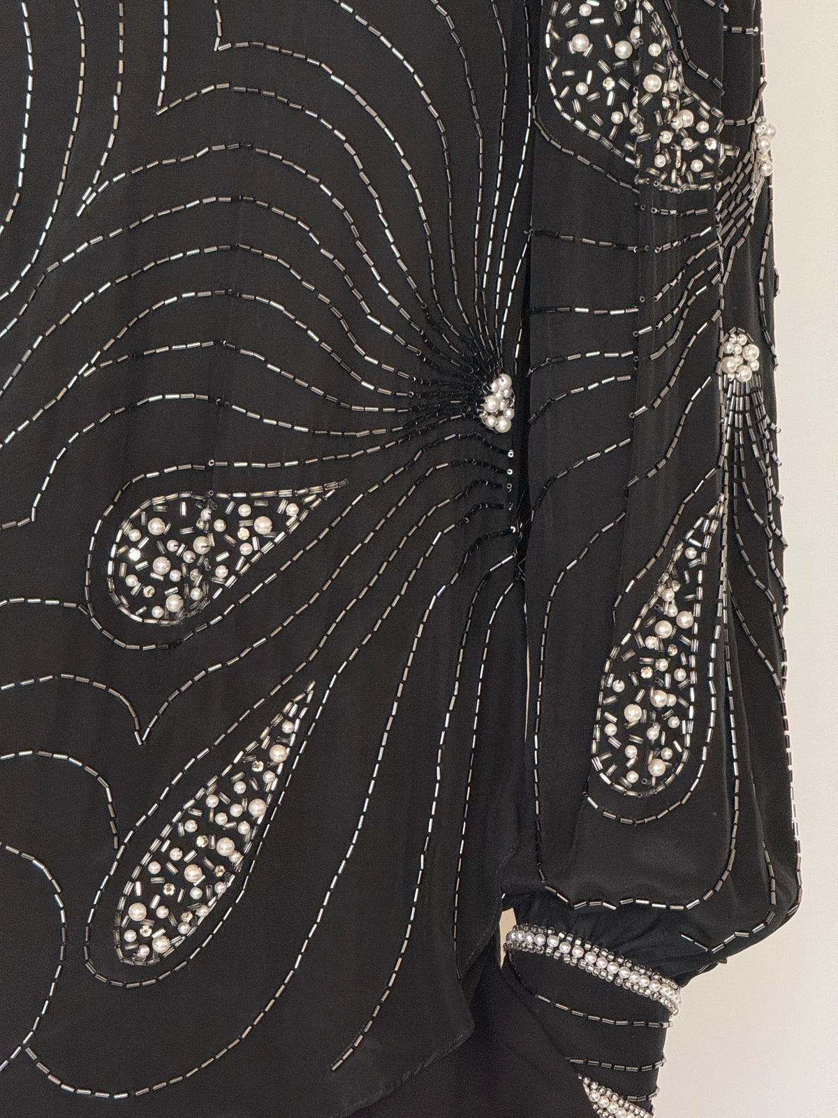 Angled front view of black silk evening blouse