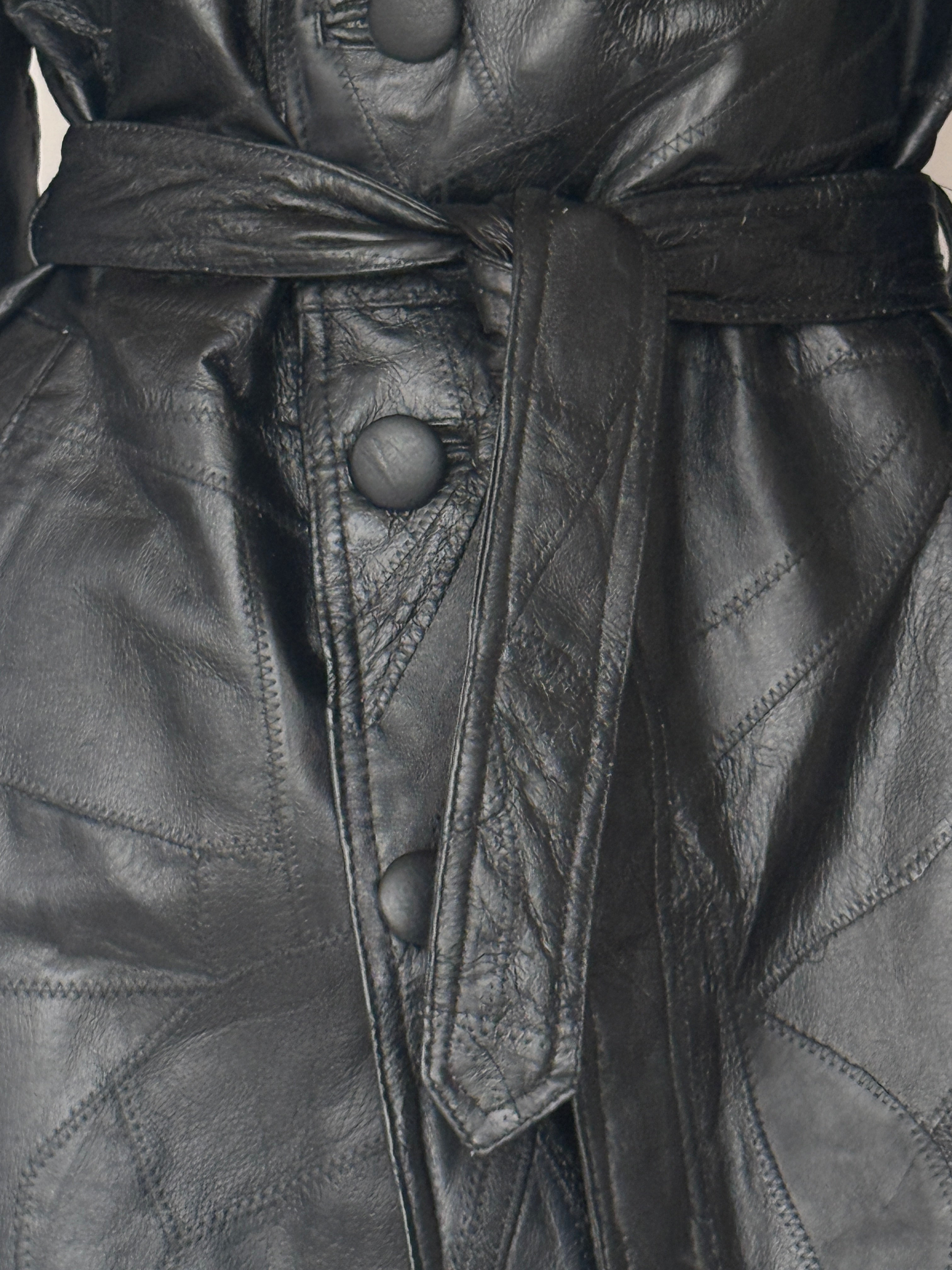 Vintage black leather trench coat belt detail