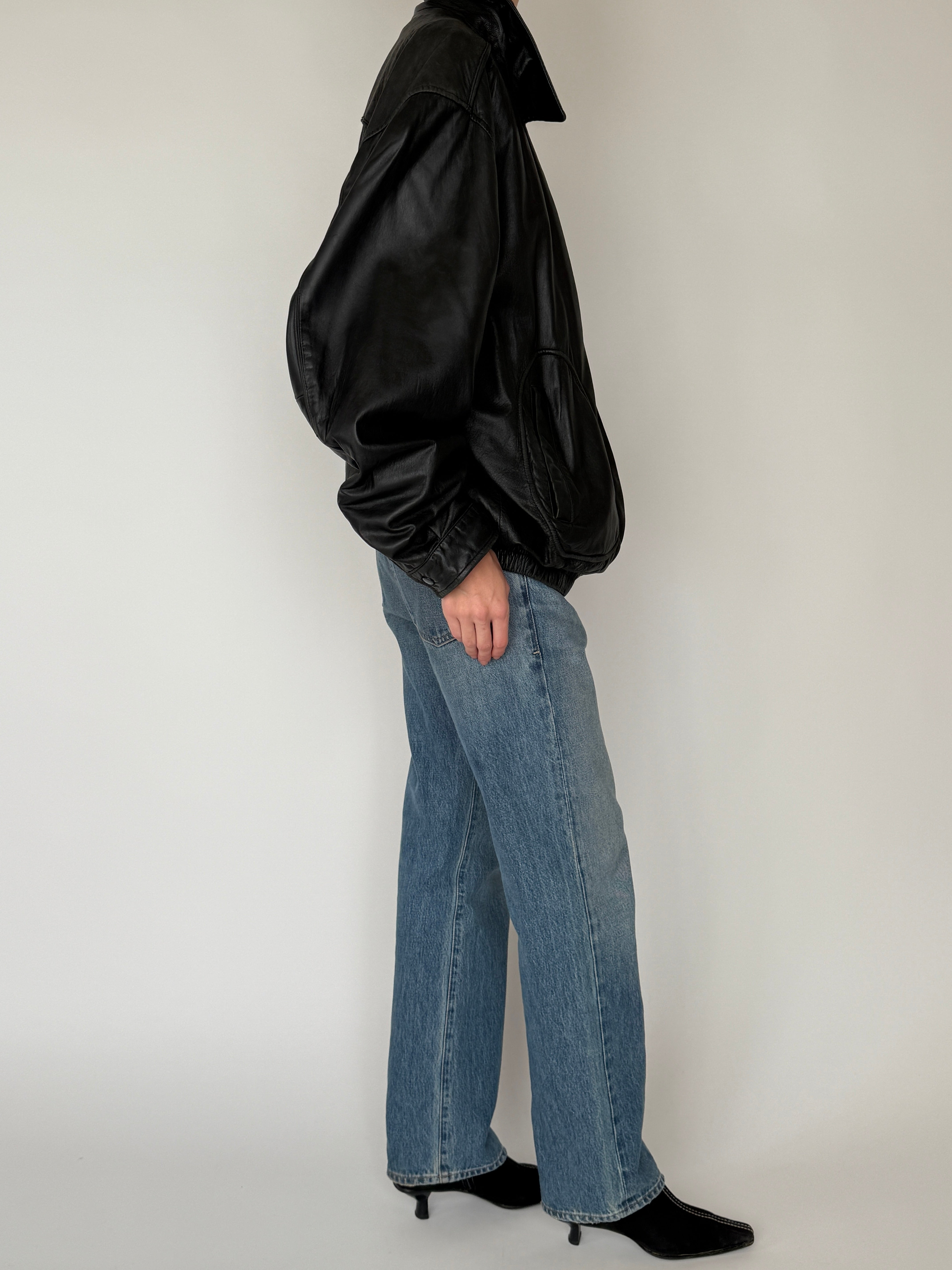 Vintage black leather bomber jacket side view drop shoulder shape