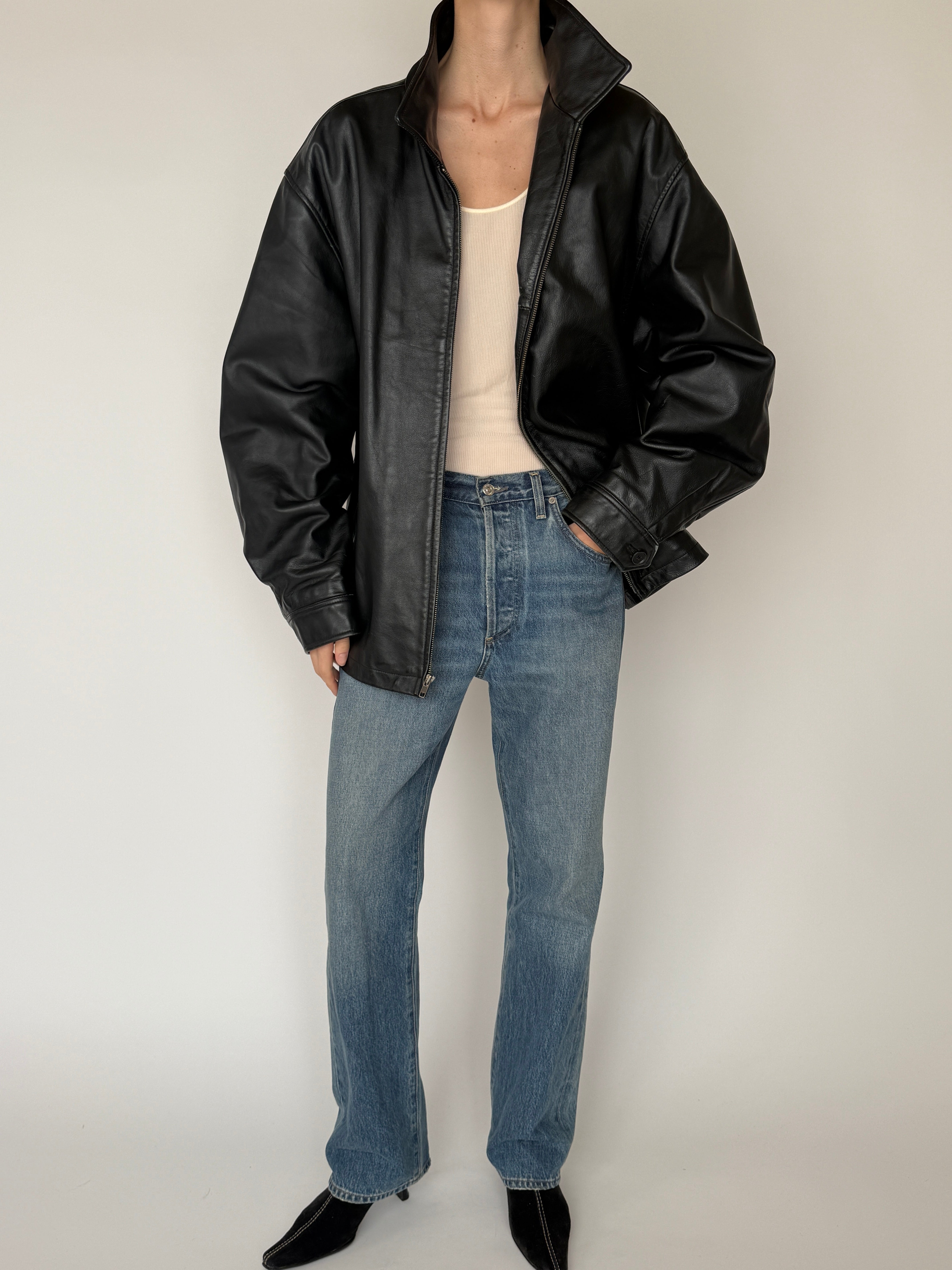 Vintage leather jacket with full-length zipper and soft leather texture in black full body