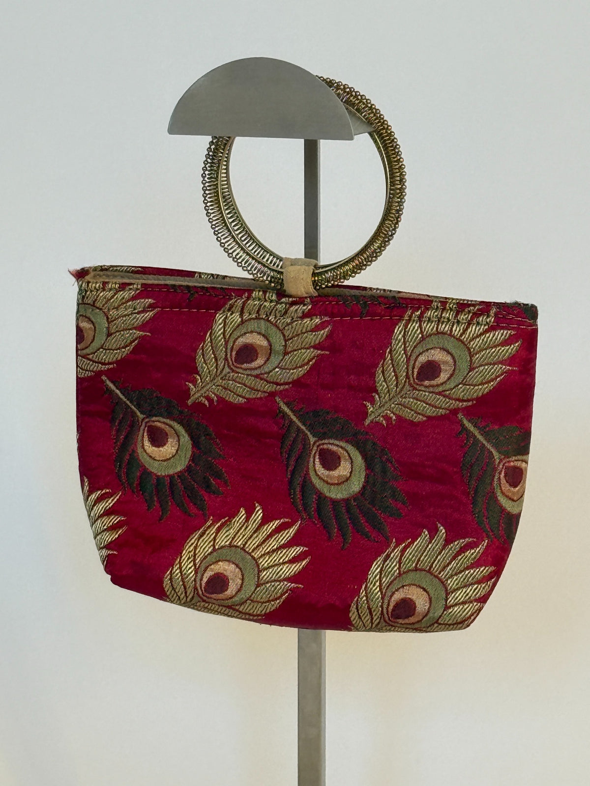 Front view of burgundy peacock brocade ring handle mini bag