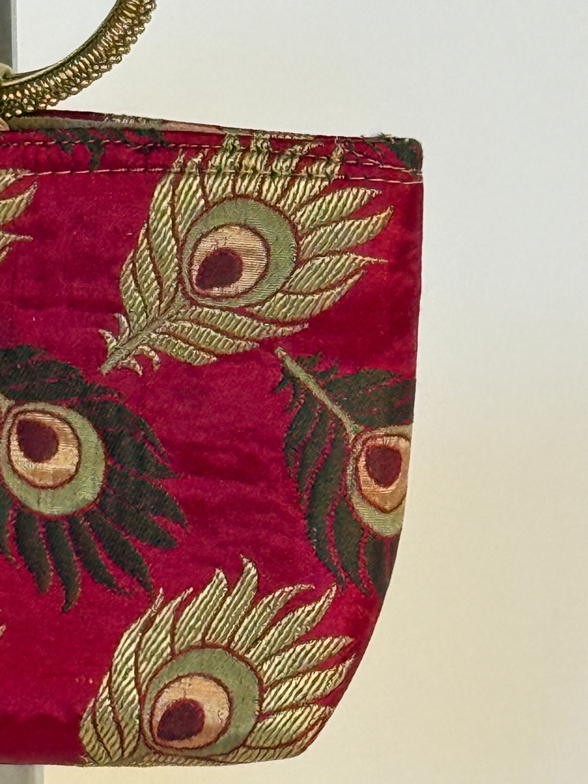 Side of burgundy peacock feather mini bag