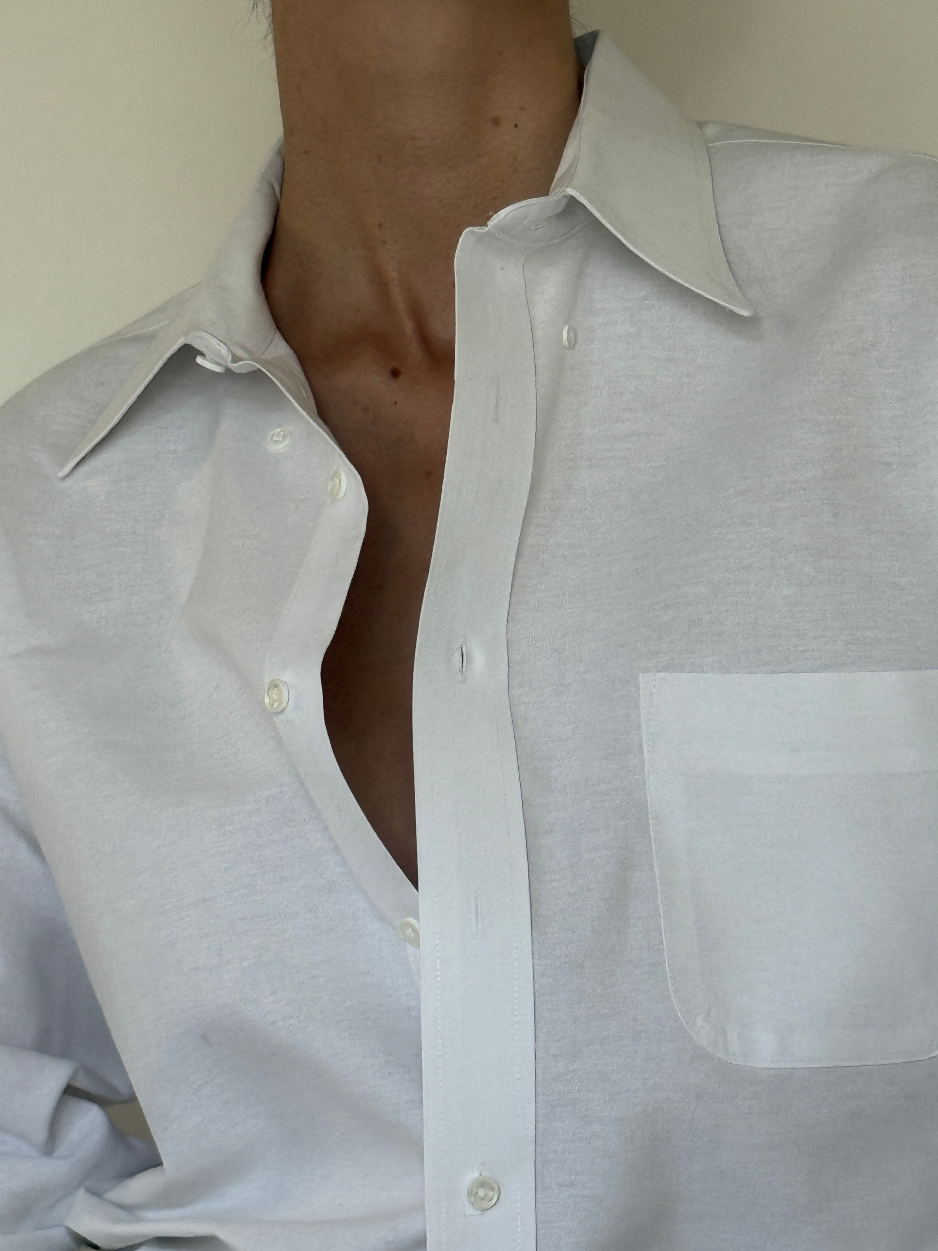 Vintage white button-up shirt fabric close-up