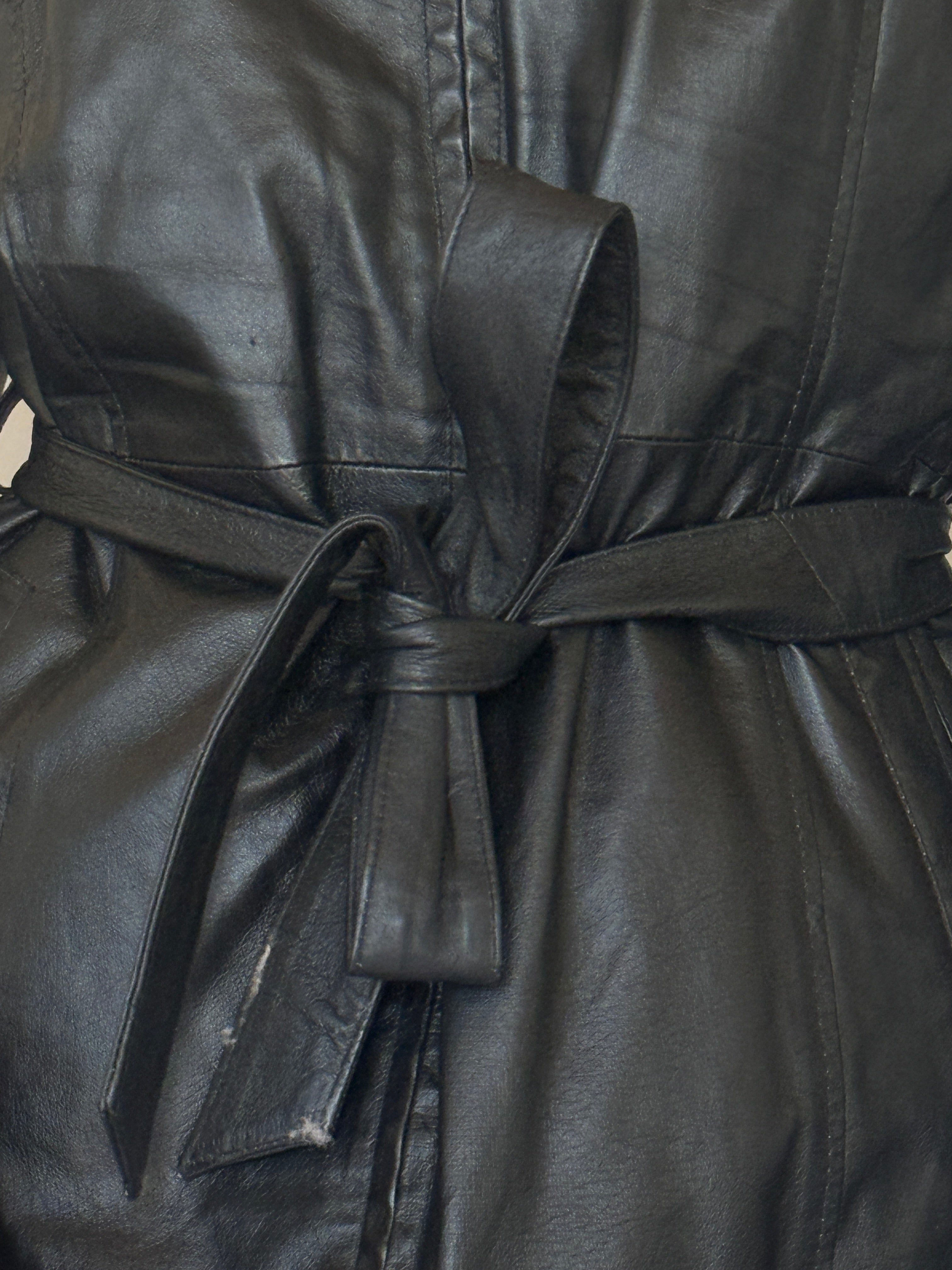 Vintage black leather jacket fabric close-up