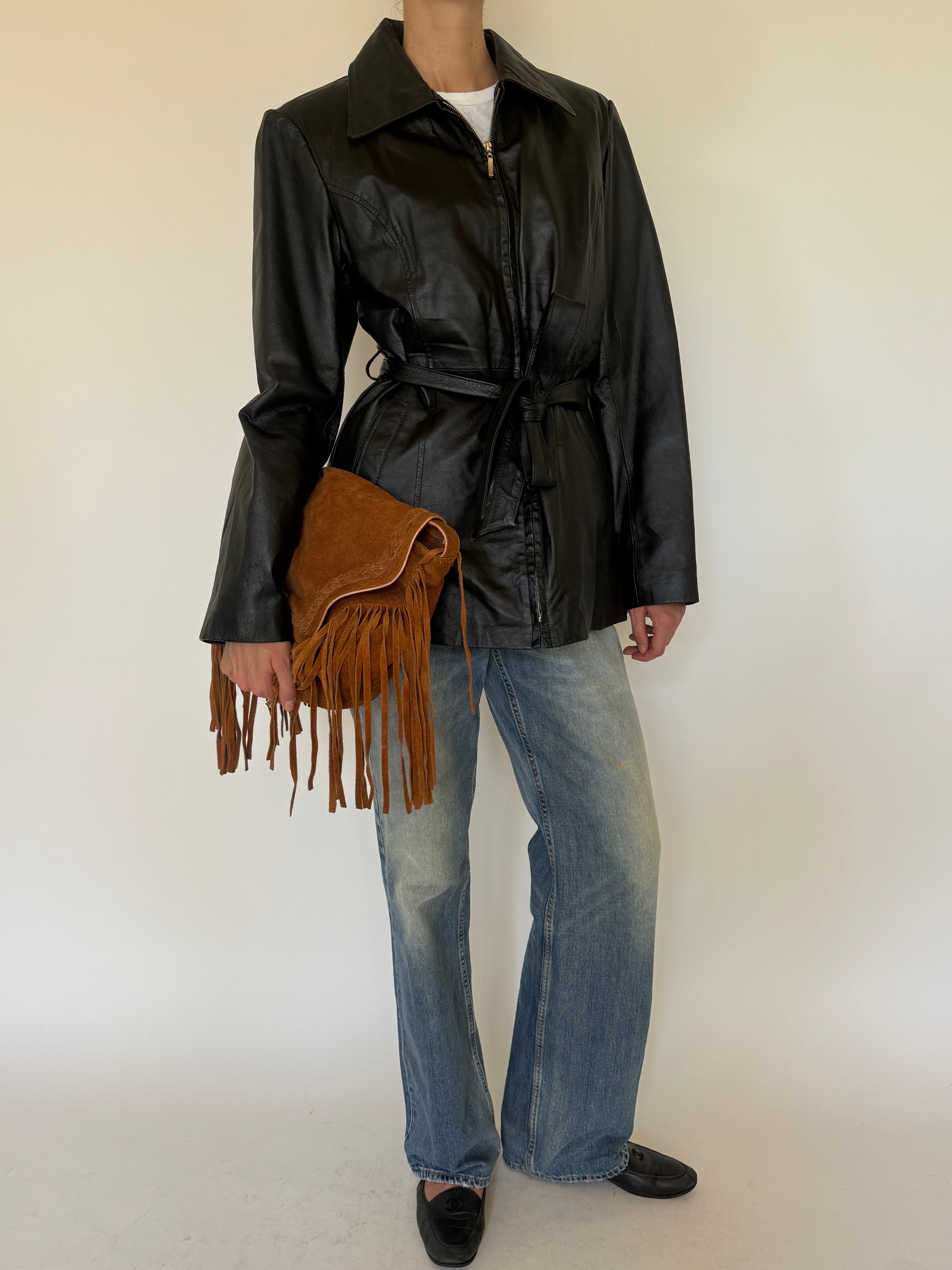 Vintage black belted leather jacket full-length angle view