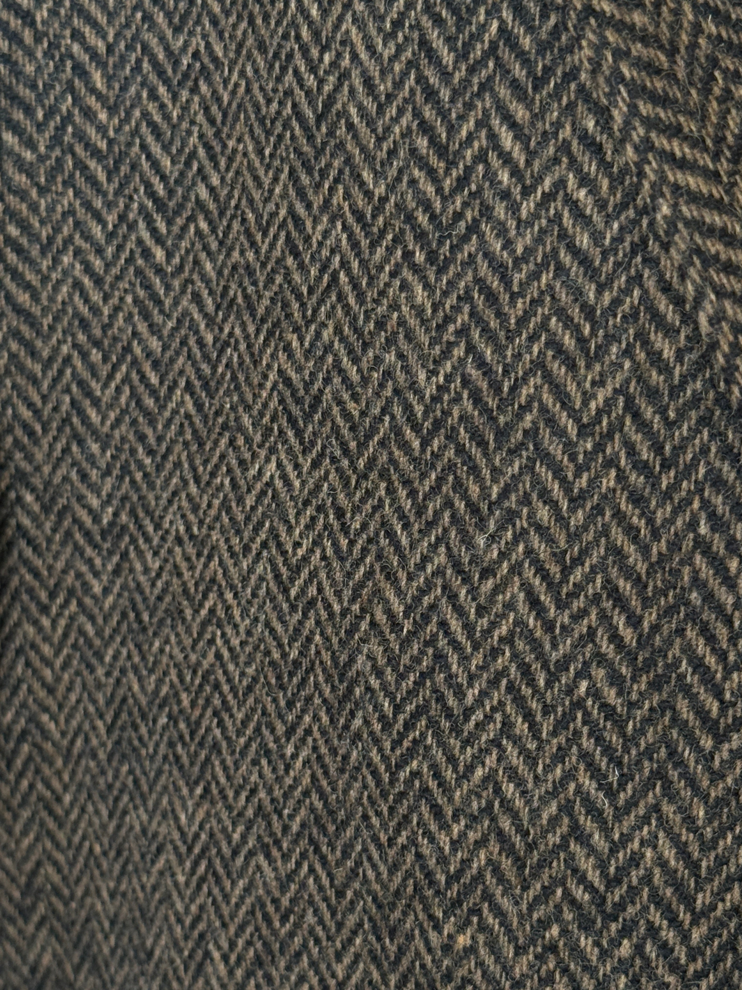 Vintage brown herringbone wool blazer fabric close-up herringbone texture