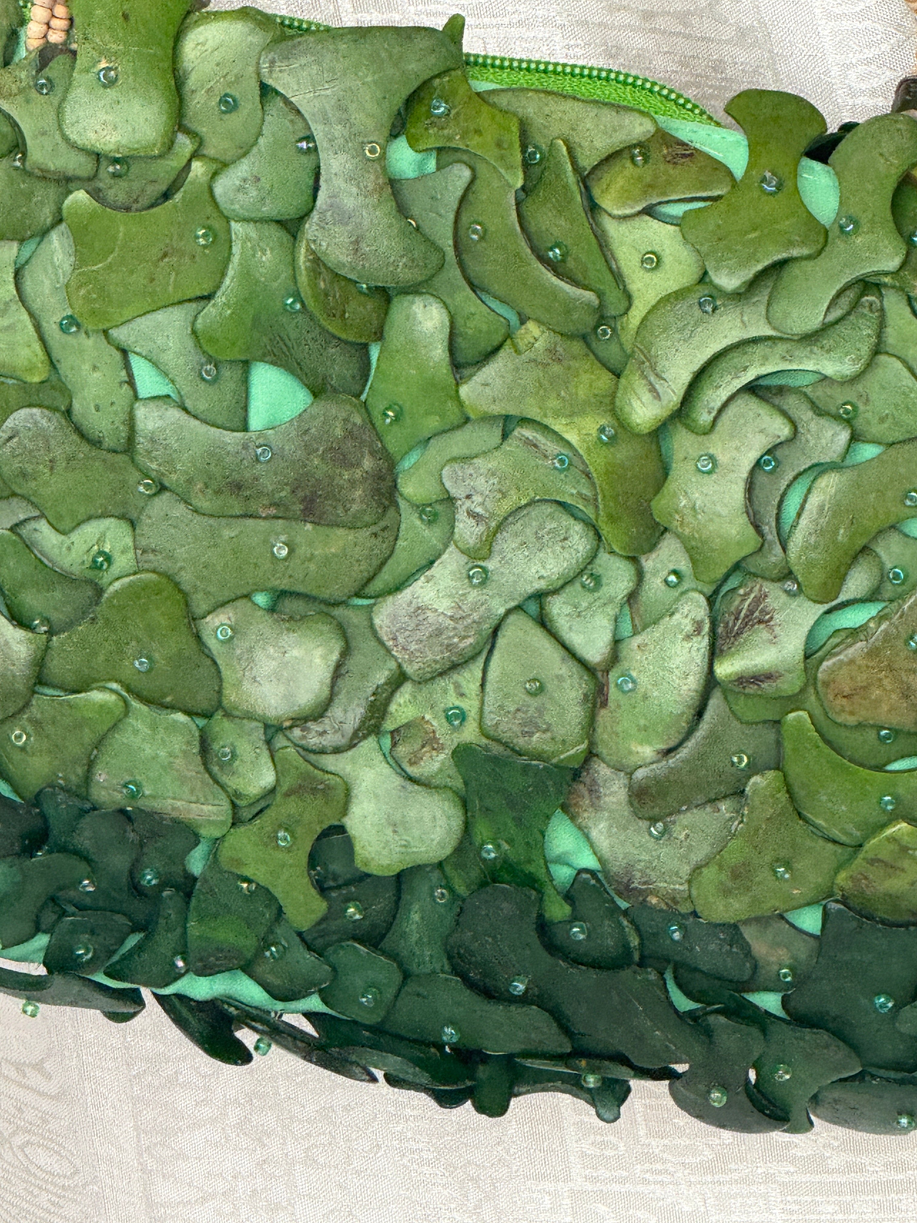 Vintage green handbag textured embellishment close-up