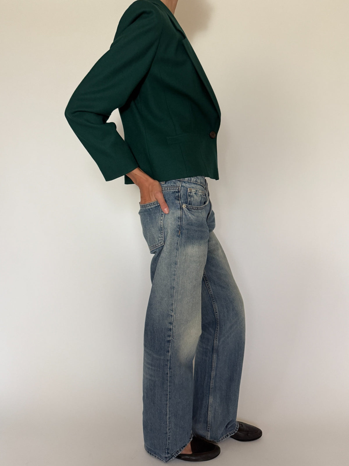 Side profile of tailored forest green blazer