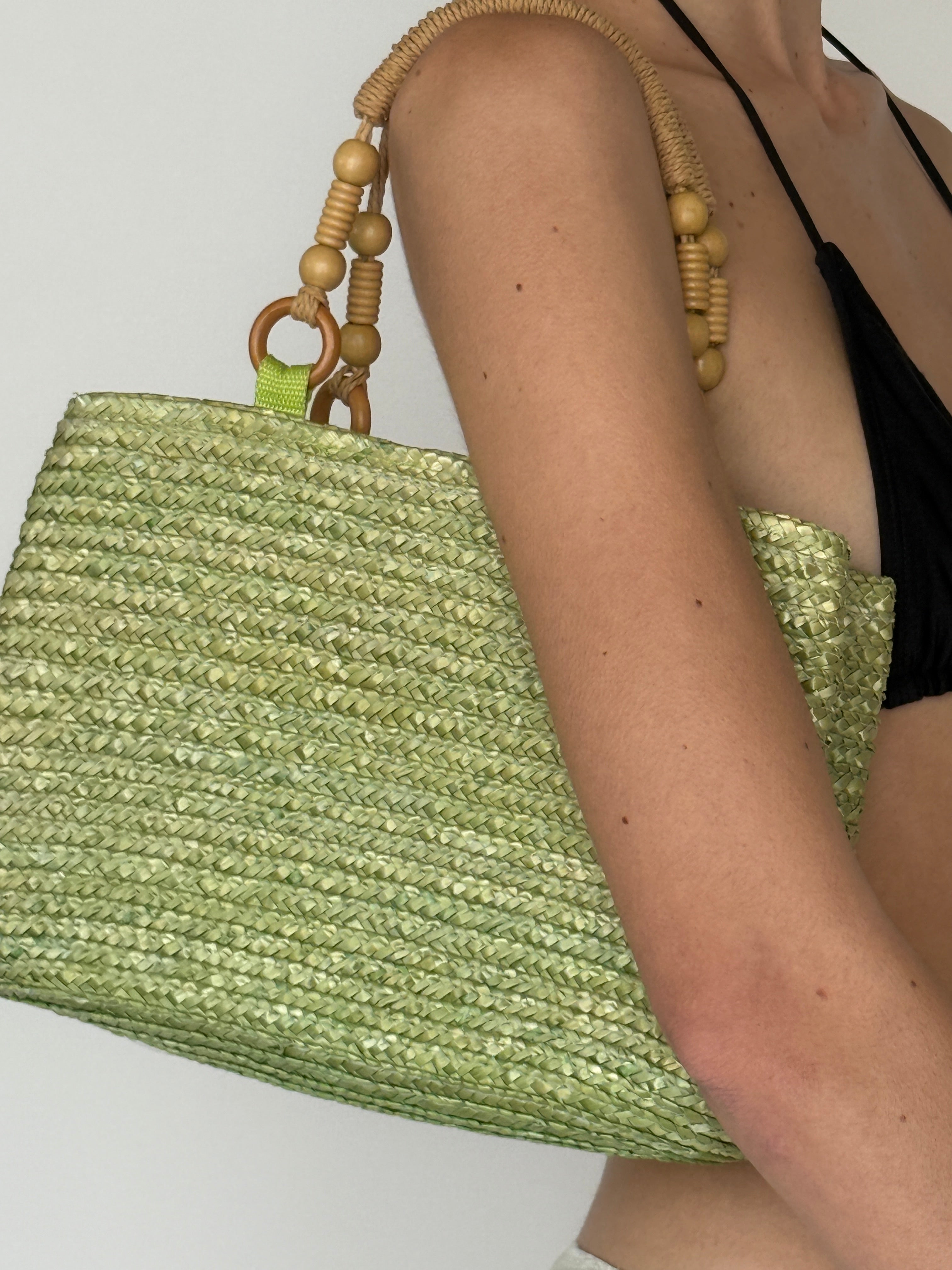 Vintage green woven straw handbag structured silhouette view