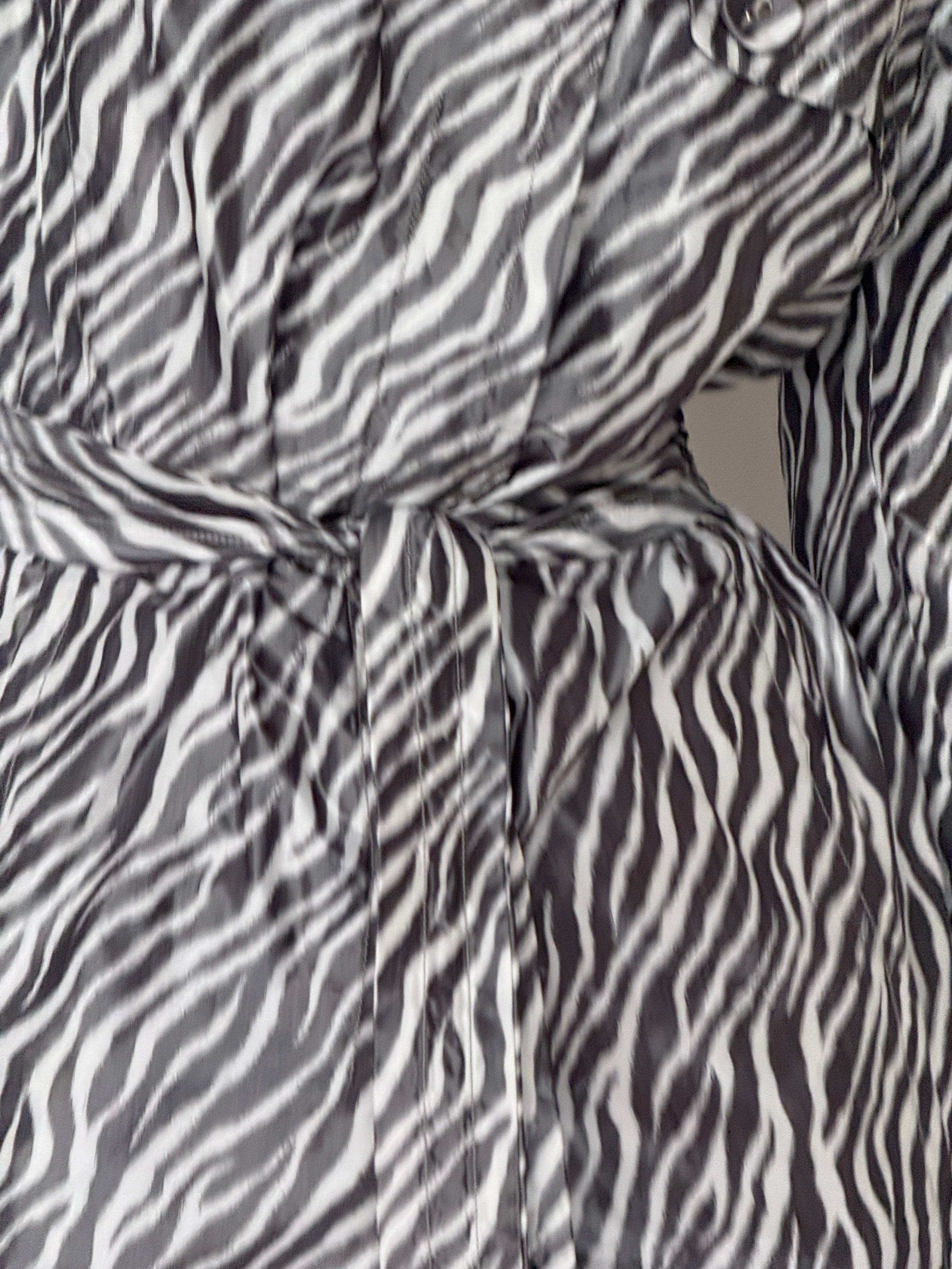 Vintage zebra print trench coat fabric close-up
