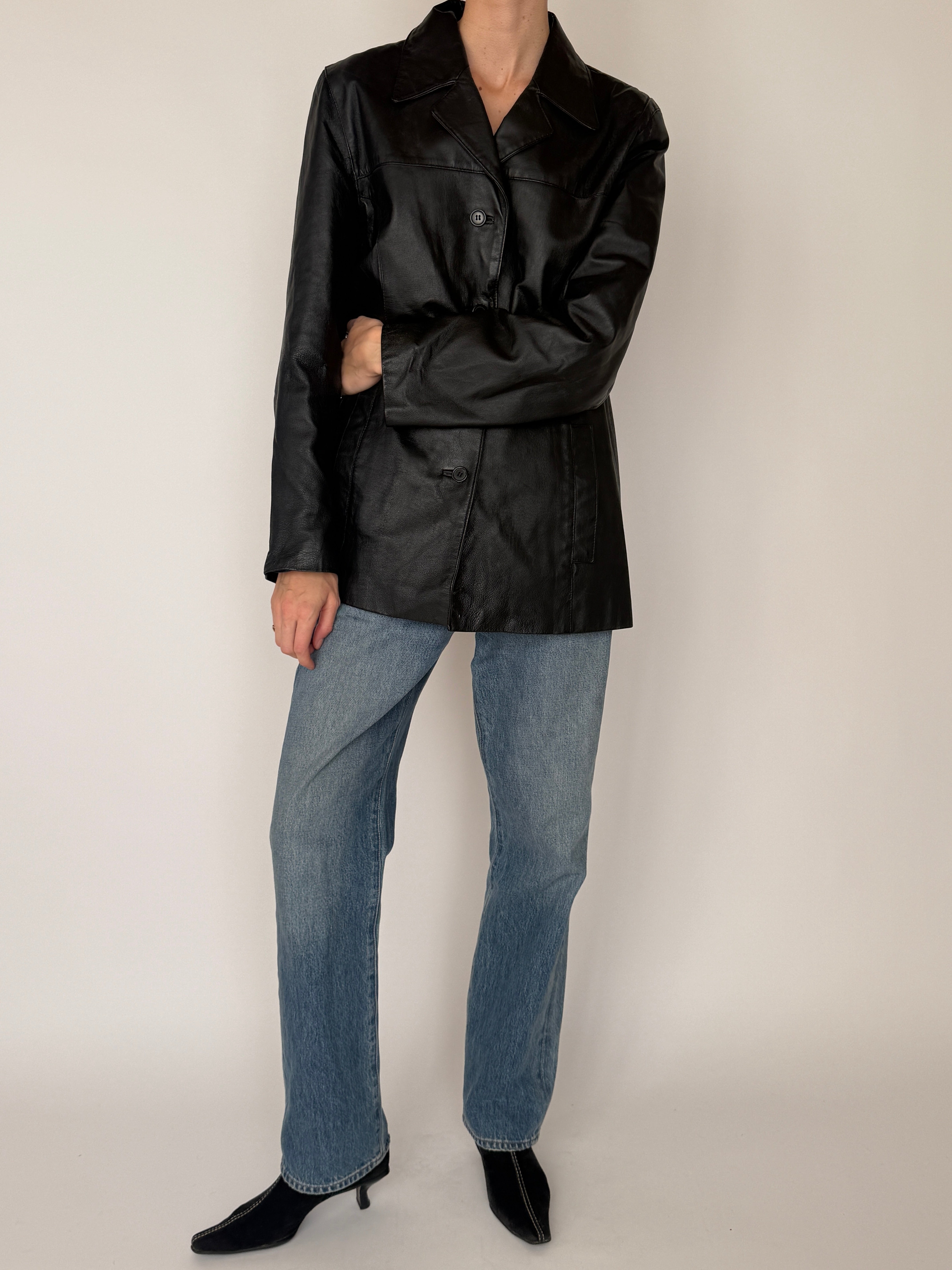 Vintage black leather jacket sleeve detail smooth leather texture