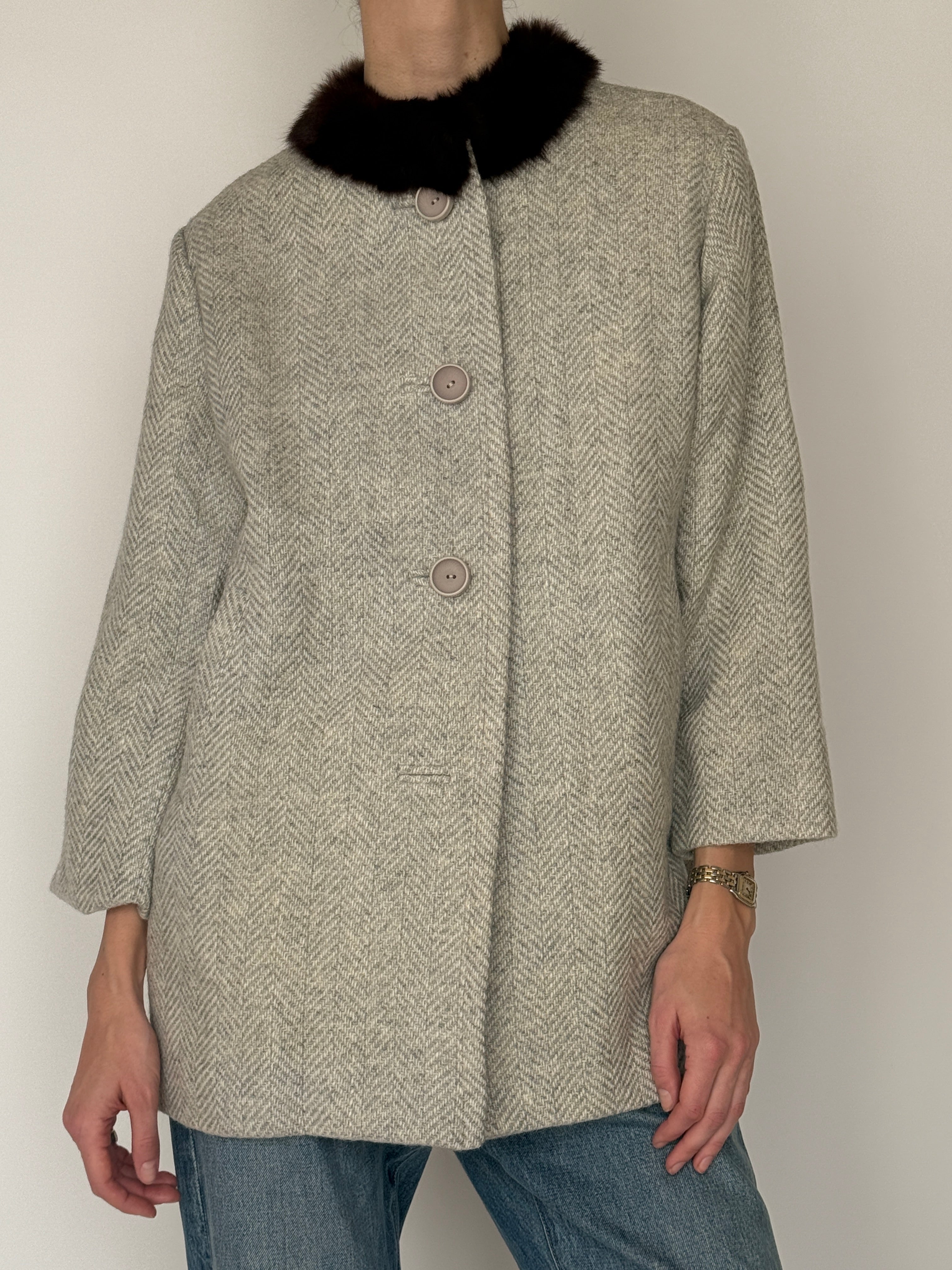 Vintage wool coat herringbone texture close up light gray