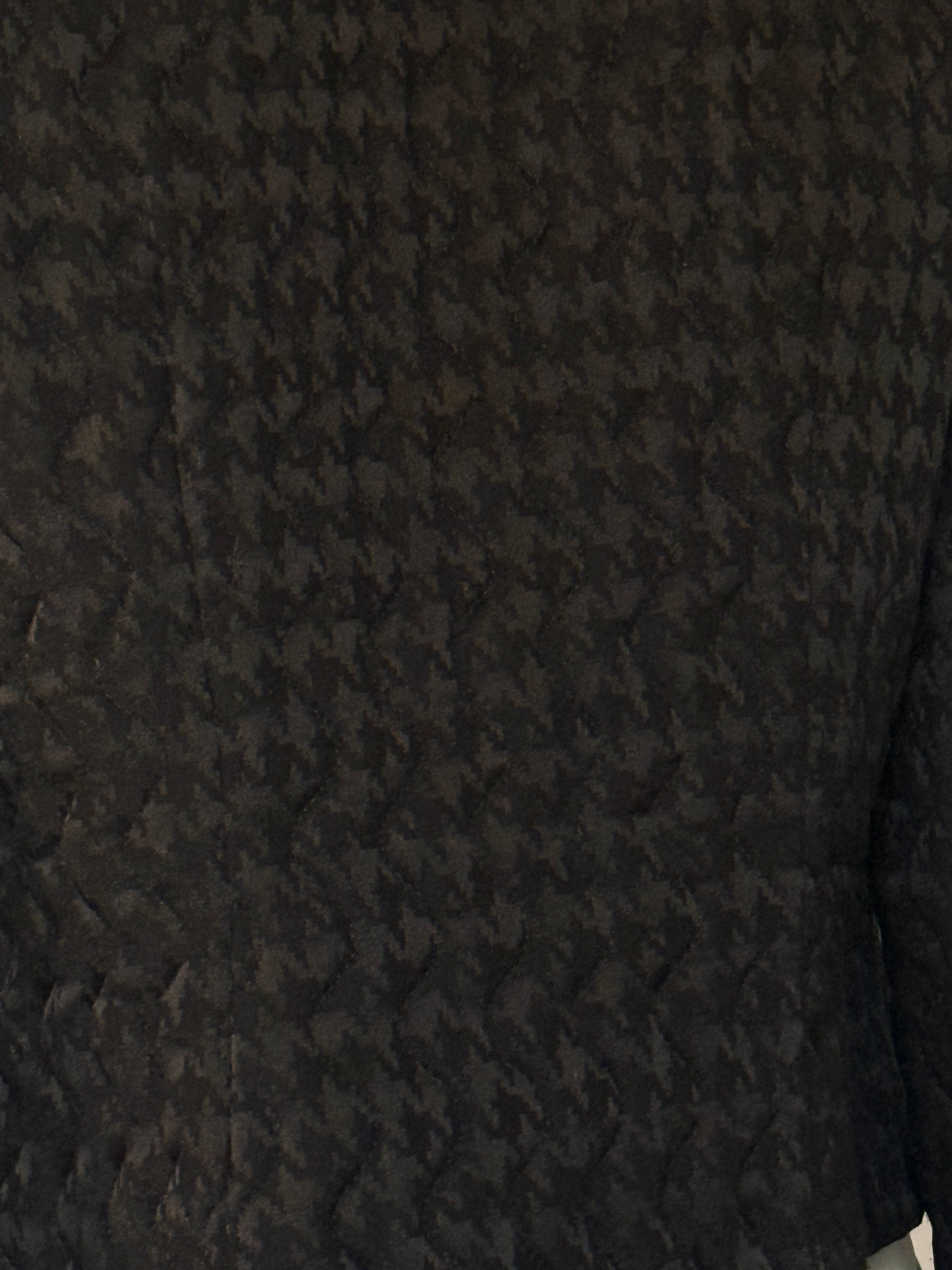 Vintage black houndstooth textured silk fabric close-up