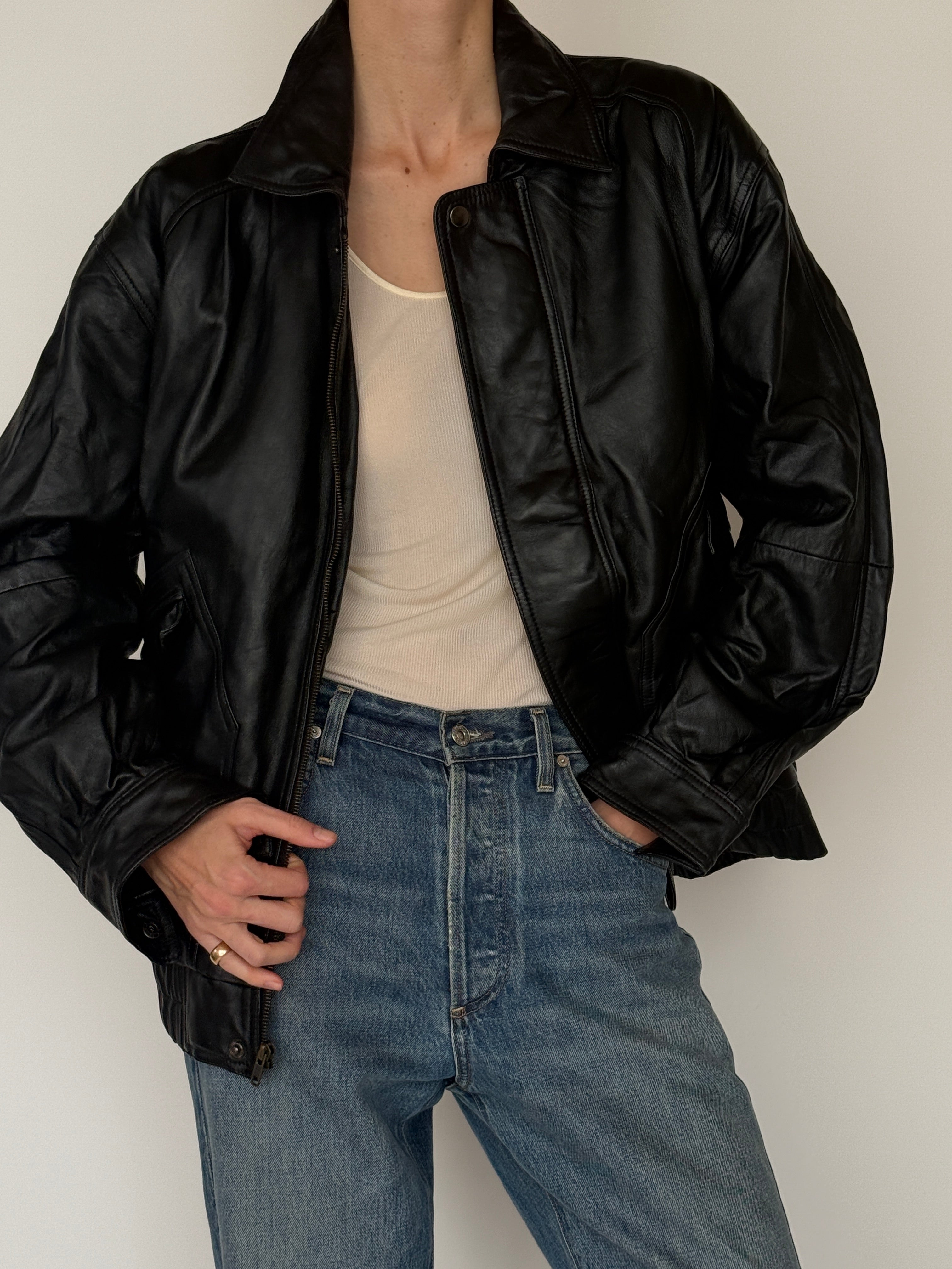Vintage black leather bomber jacket pocket detail
