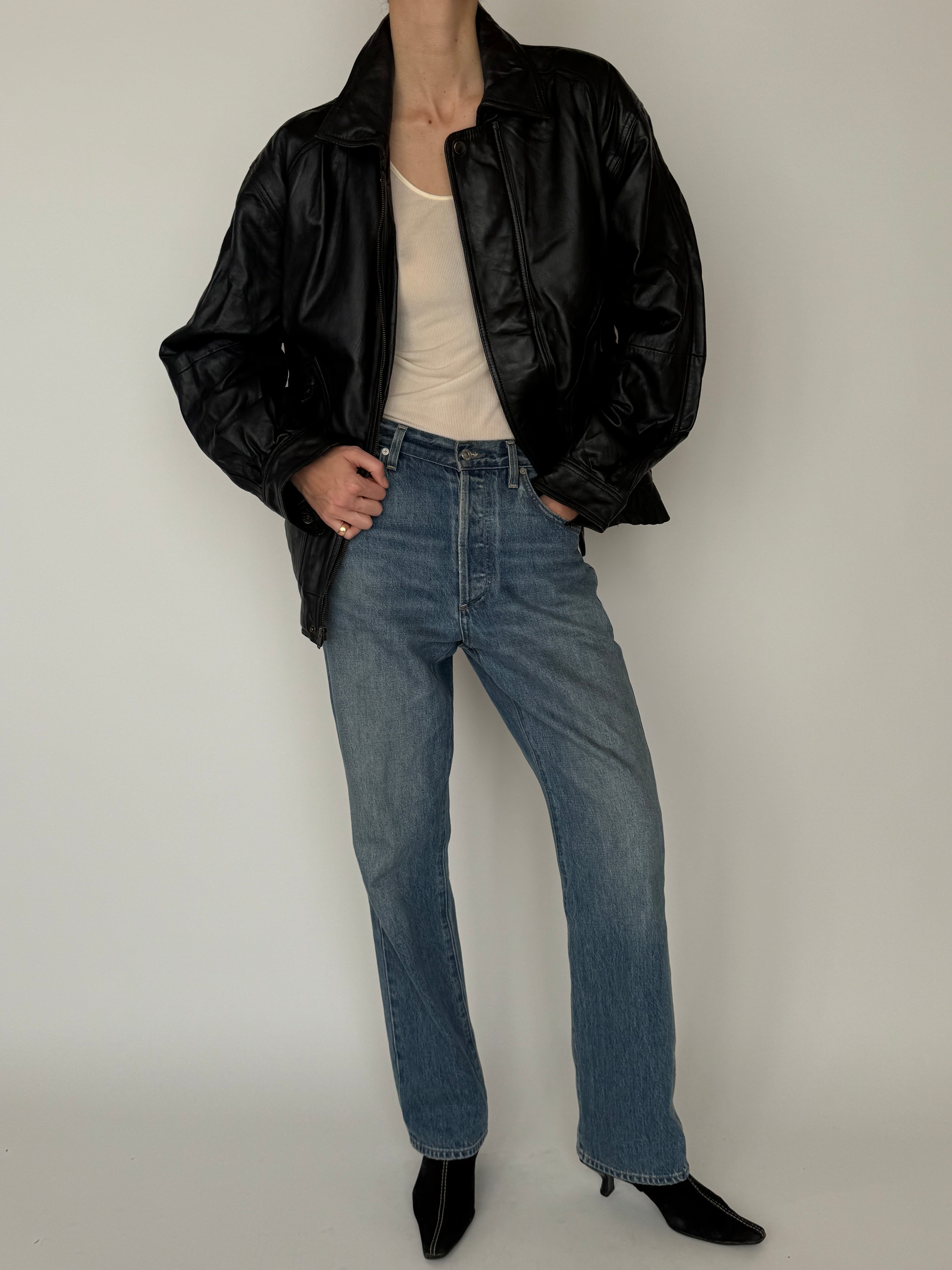 Vintage black leather bomber jacket zipper detail