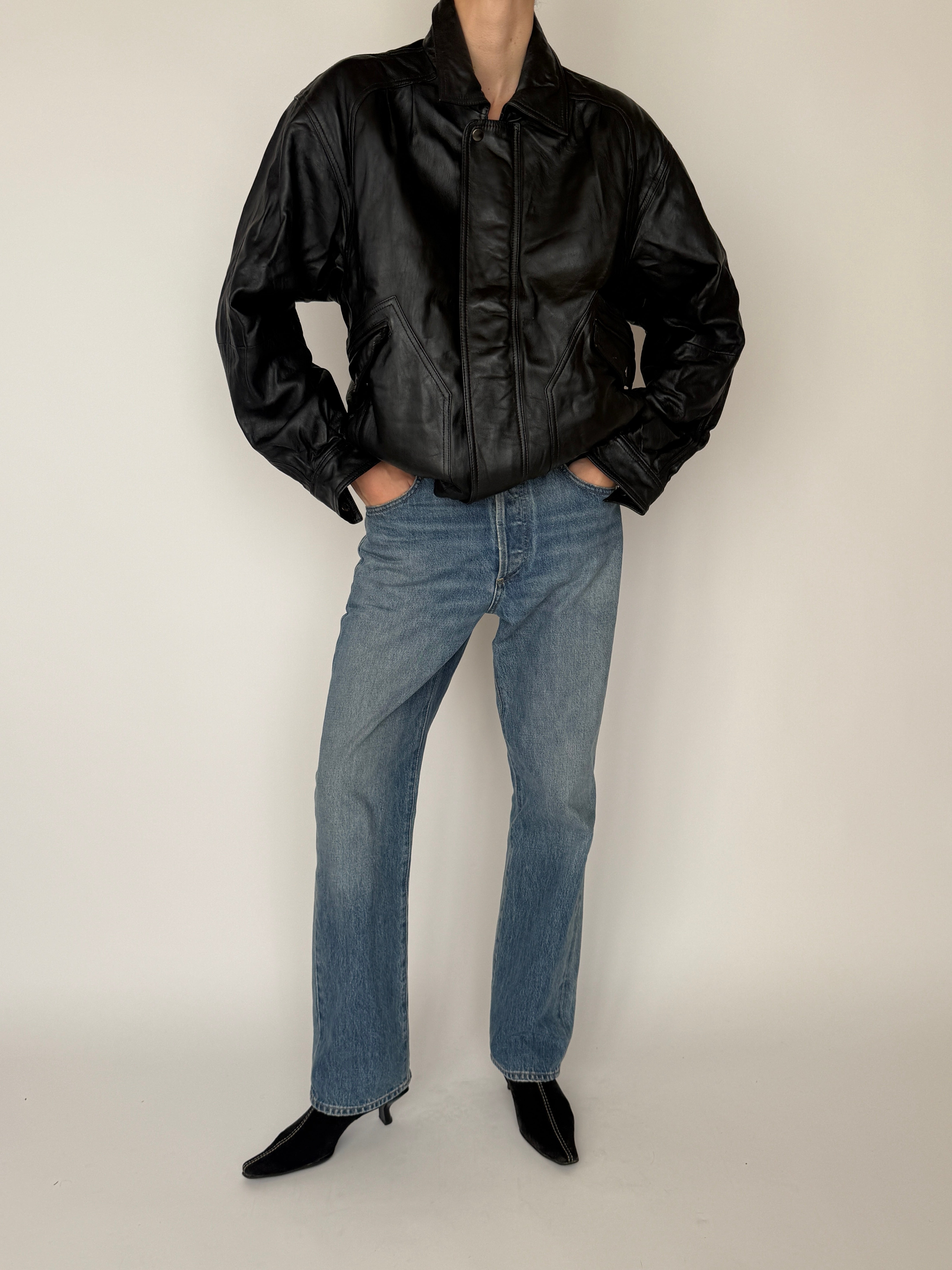 Vintage black leather bomber jacket waistband detail