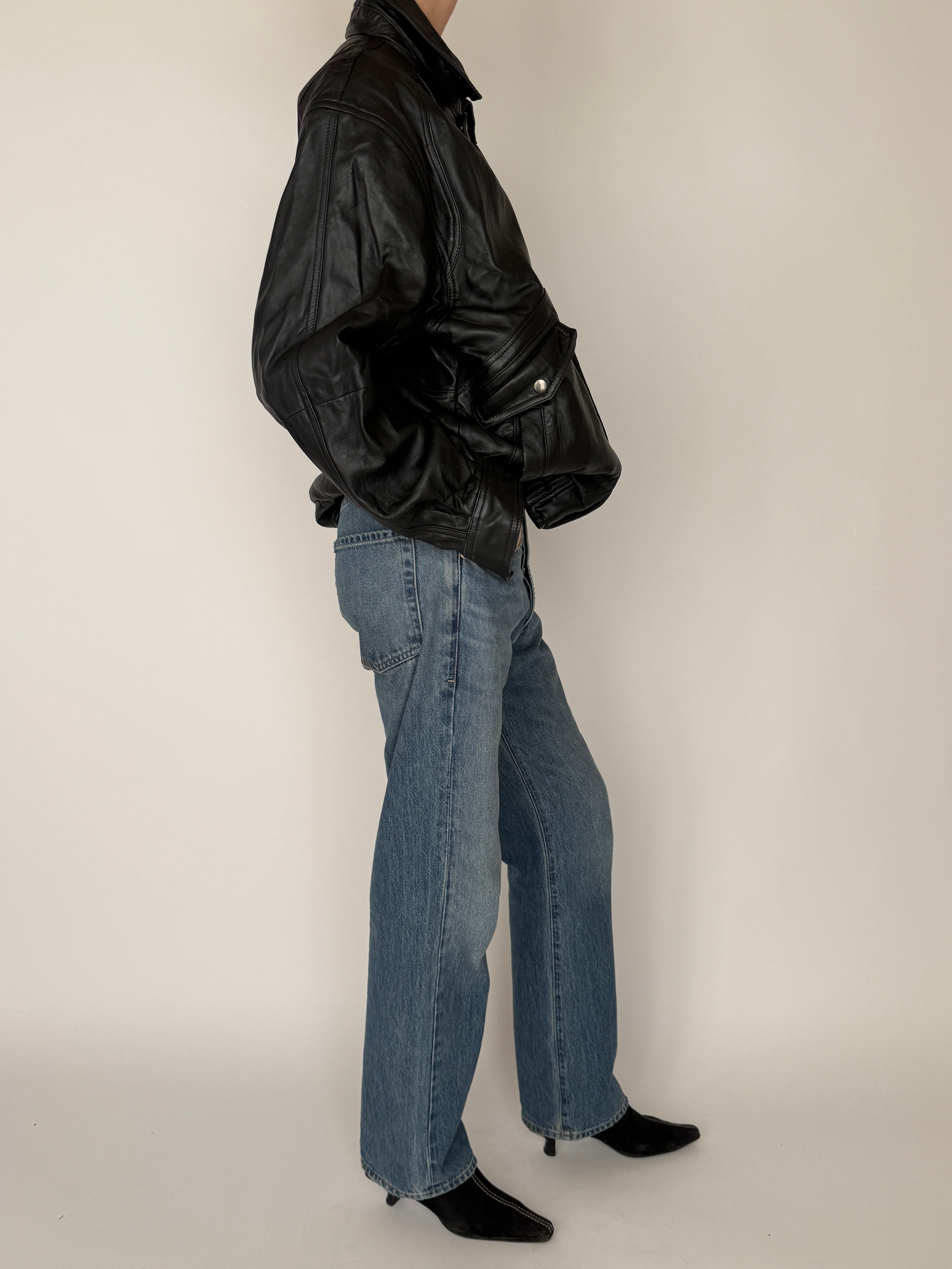 Vintage black leather bomber jacket side view