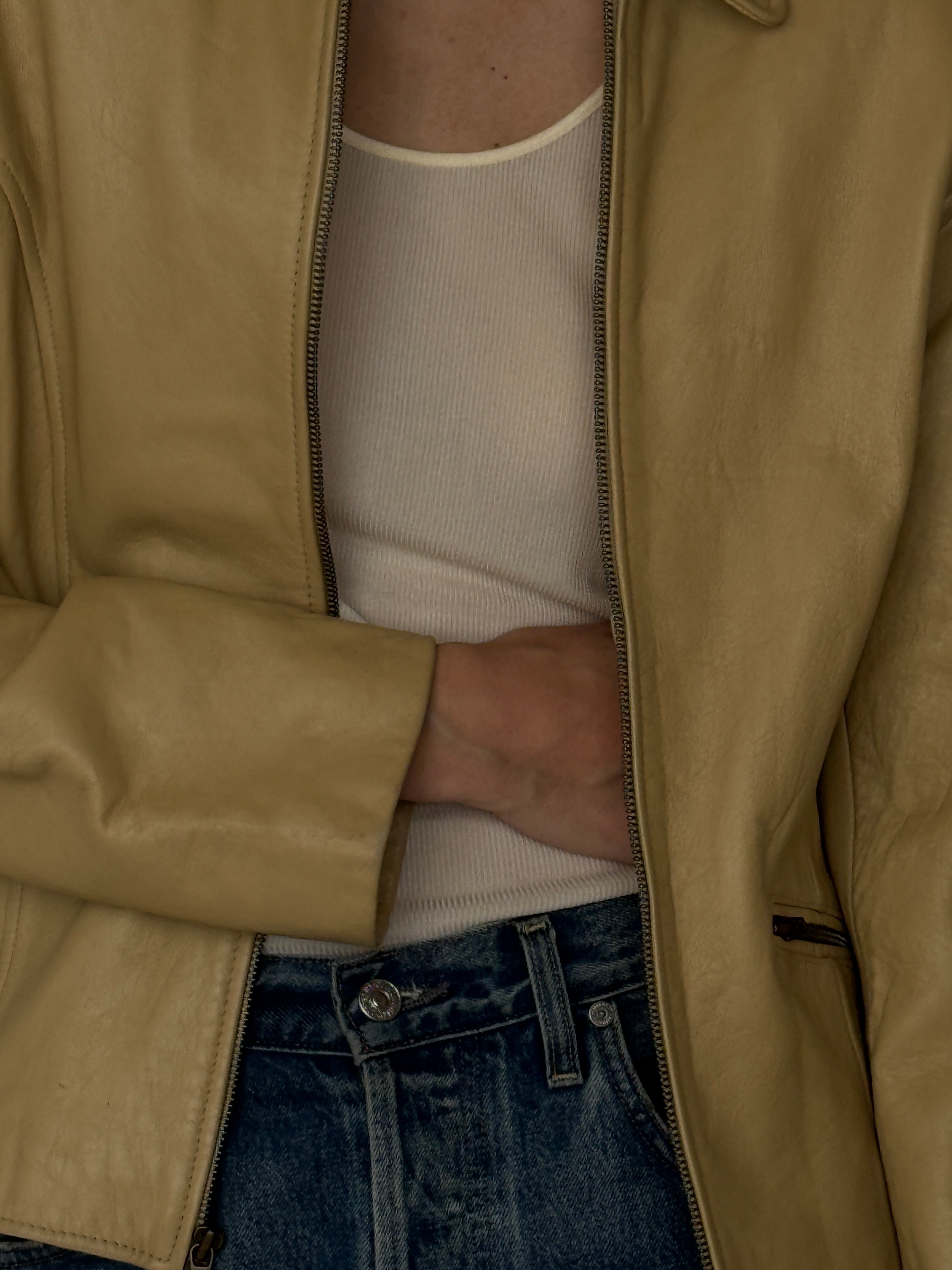 Vintage beige leather jacket fabric close-up