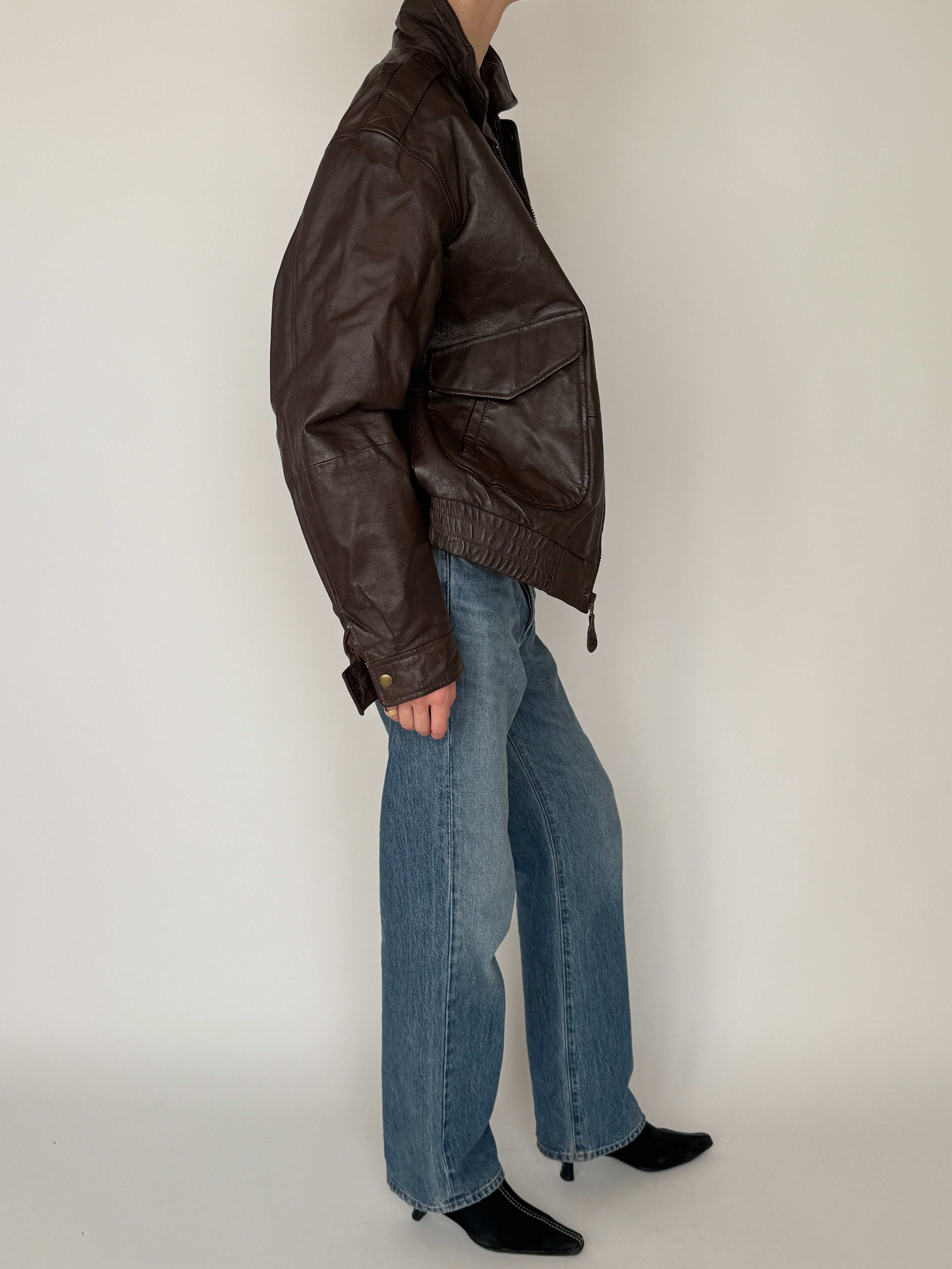 Vintage leather jacket dark brown side view full-body