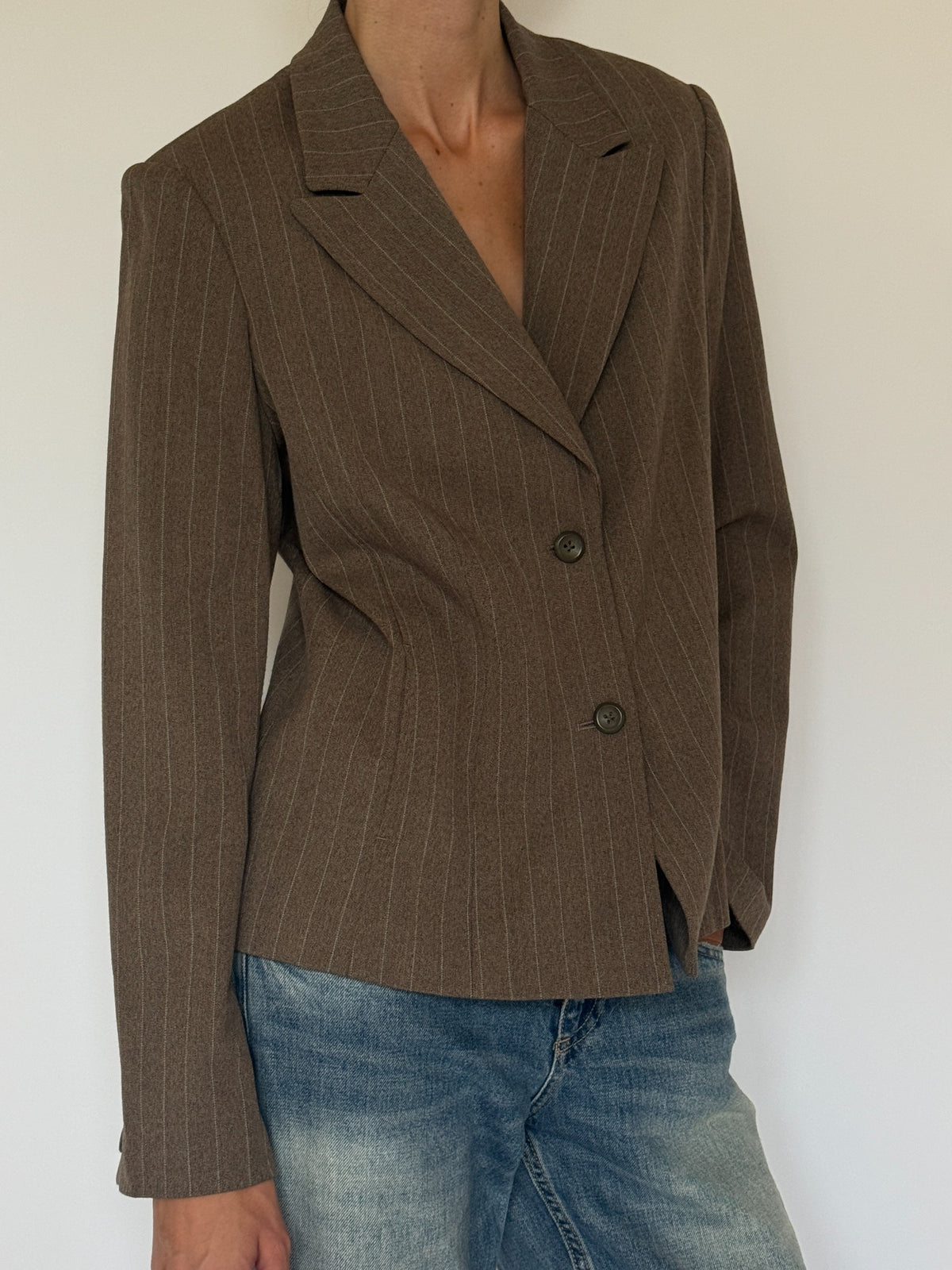 Three-quarter front view showing tailored waist