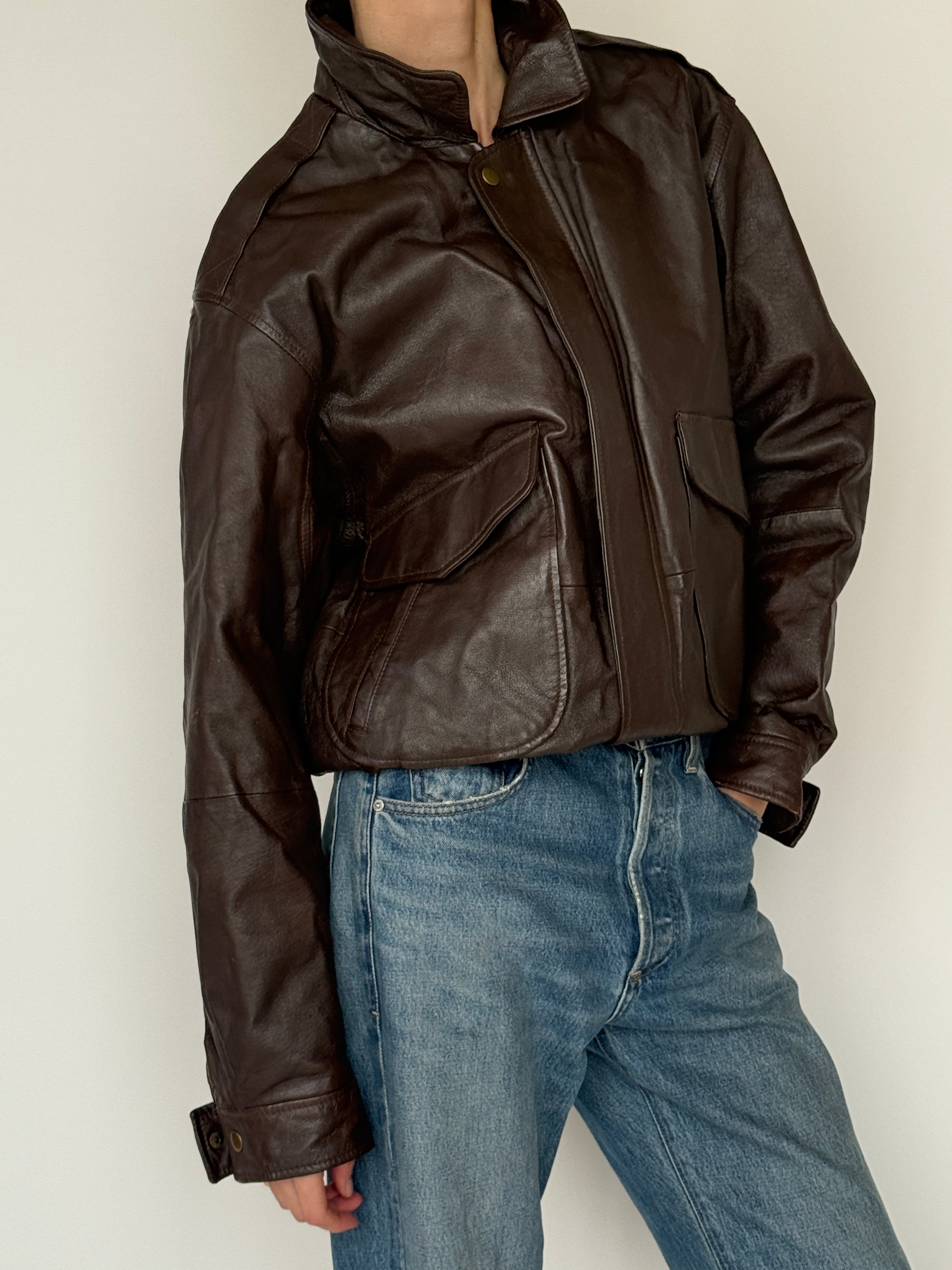 Vintage dark brown leather jacket fabric close-up