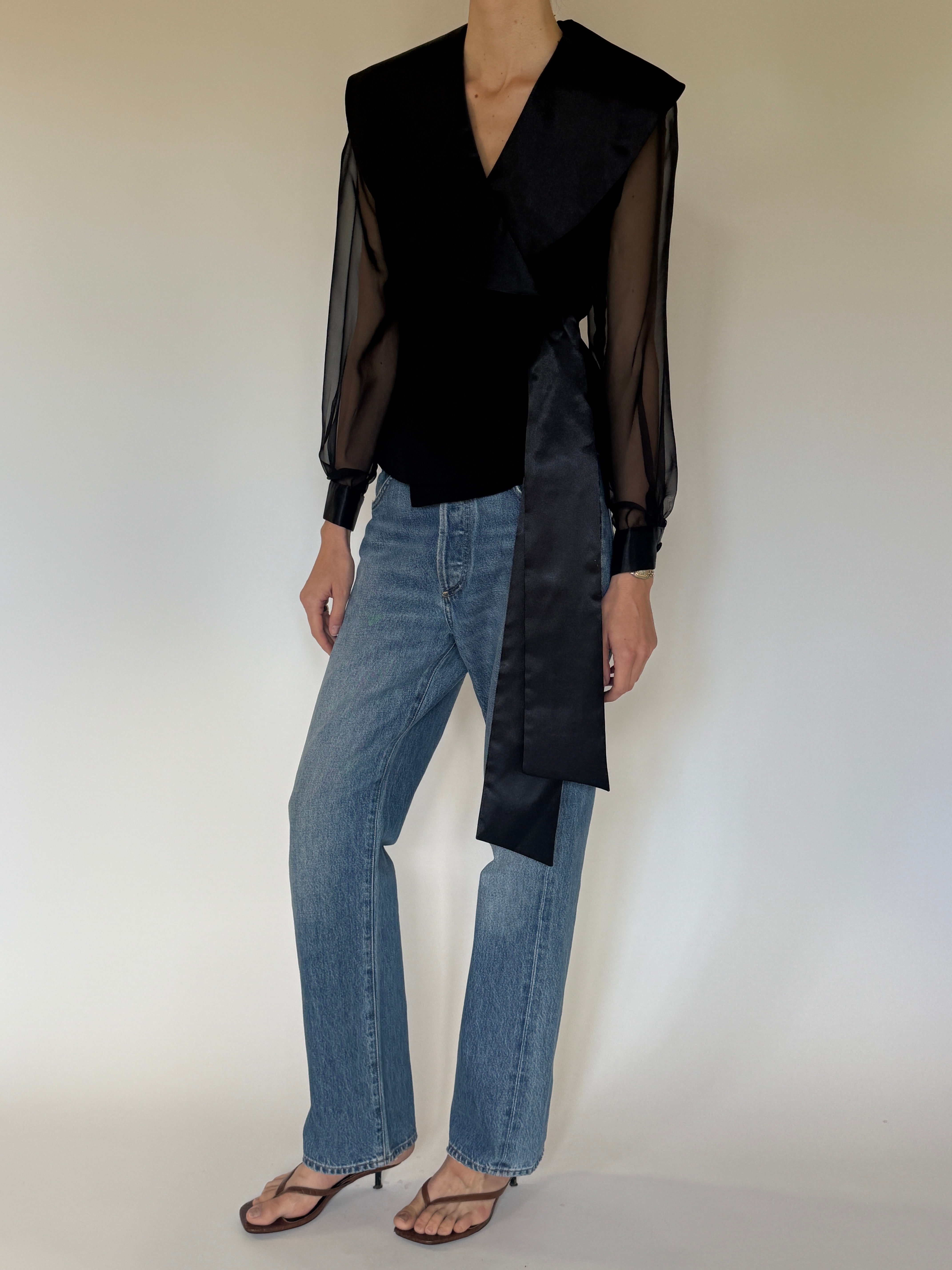 Vintage black wrap blouse front view with oversized satin shawl collar and sheer sleeves